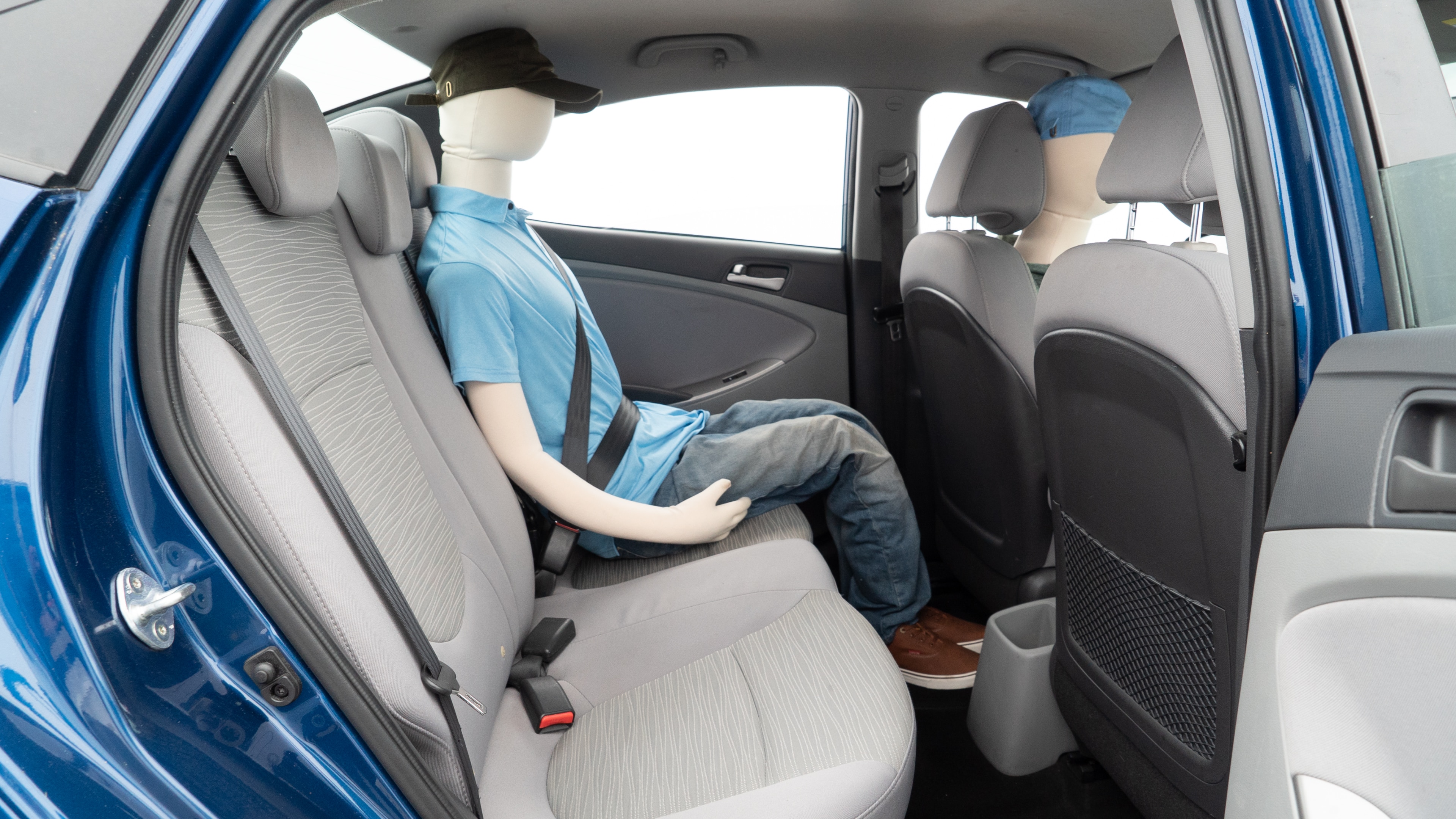 A series of second-row backseat photos is shown including one seating a baby seat and one seating a 6'1" mannequin.