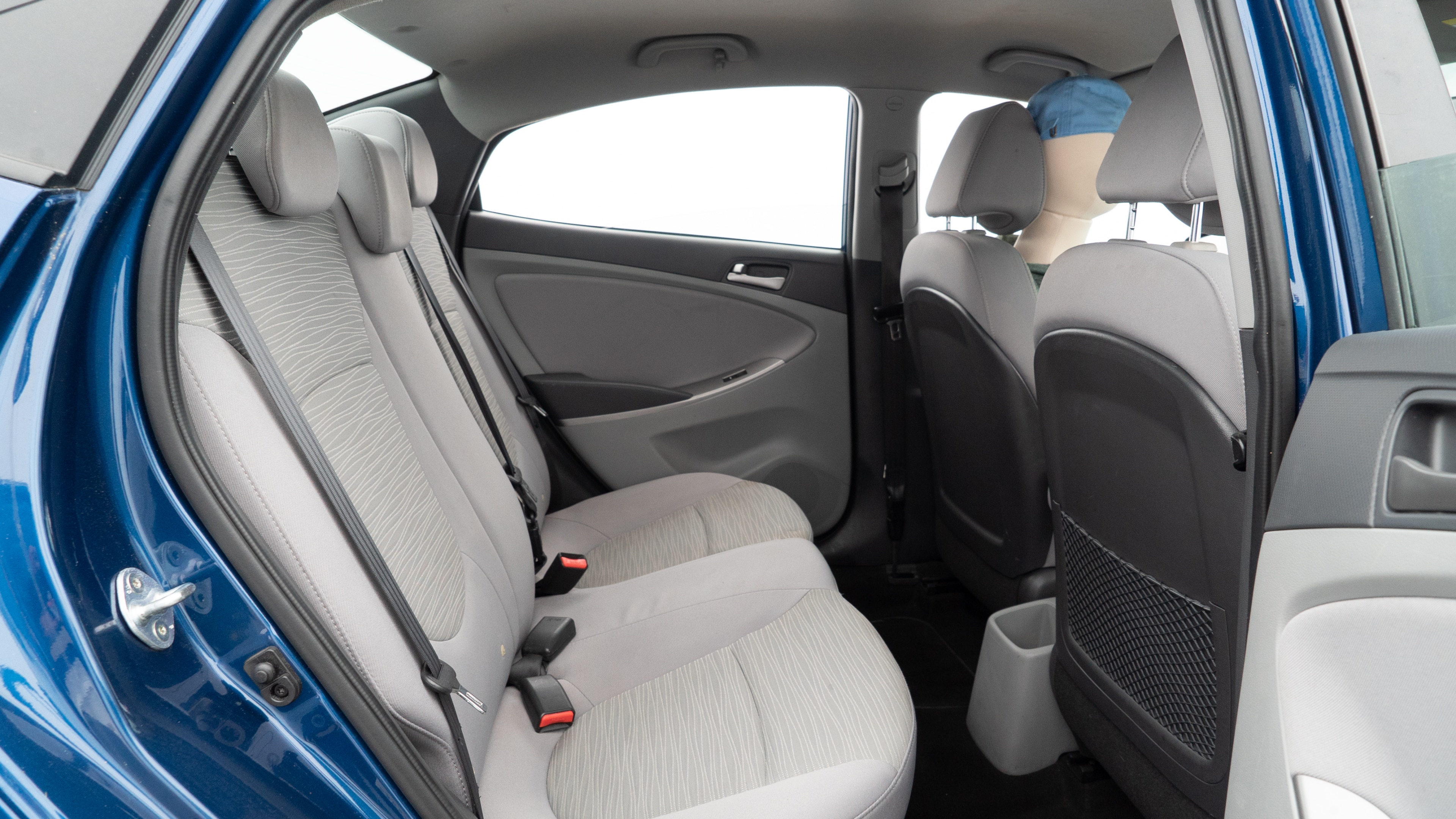 A series of second-row backseat photos is shown including one seating a baby seat and one seating a 6'1" mannequin.