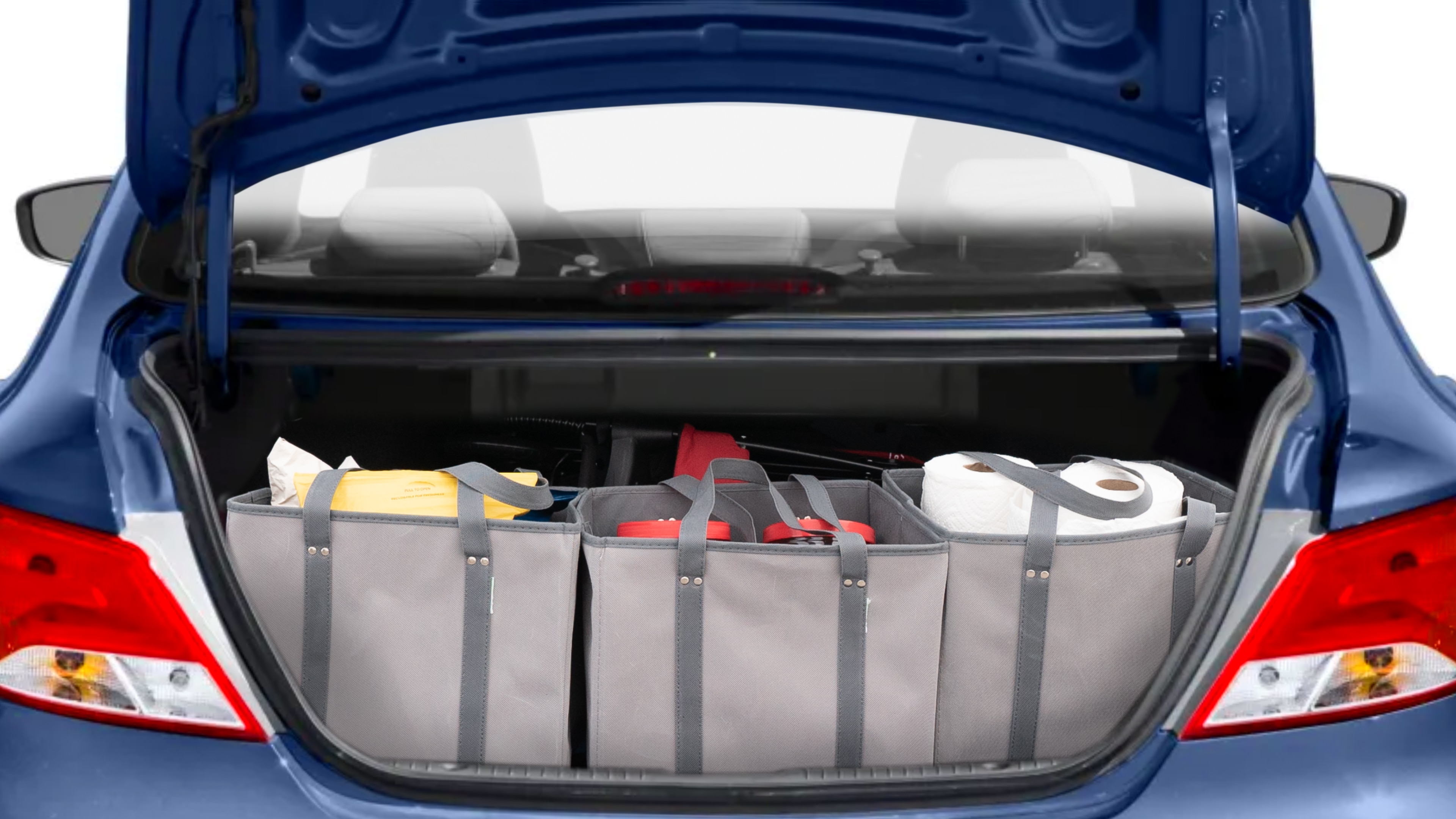 The trunk lid is open showing full view of the trunk. A baby stroller, three grocery carriers, two camping chairs in the carrying bag, and a set of golf clubs are placed inside.
