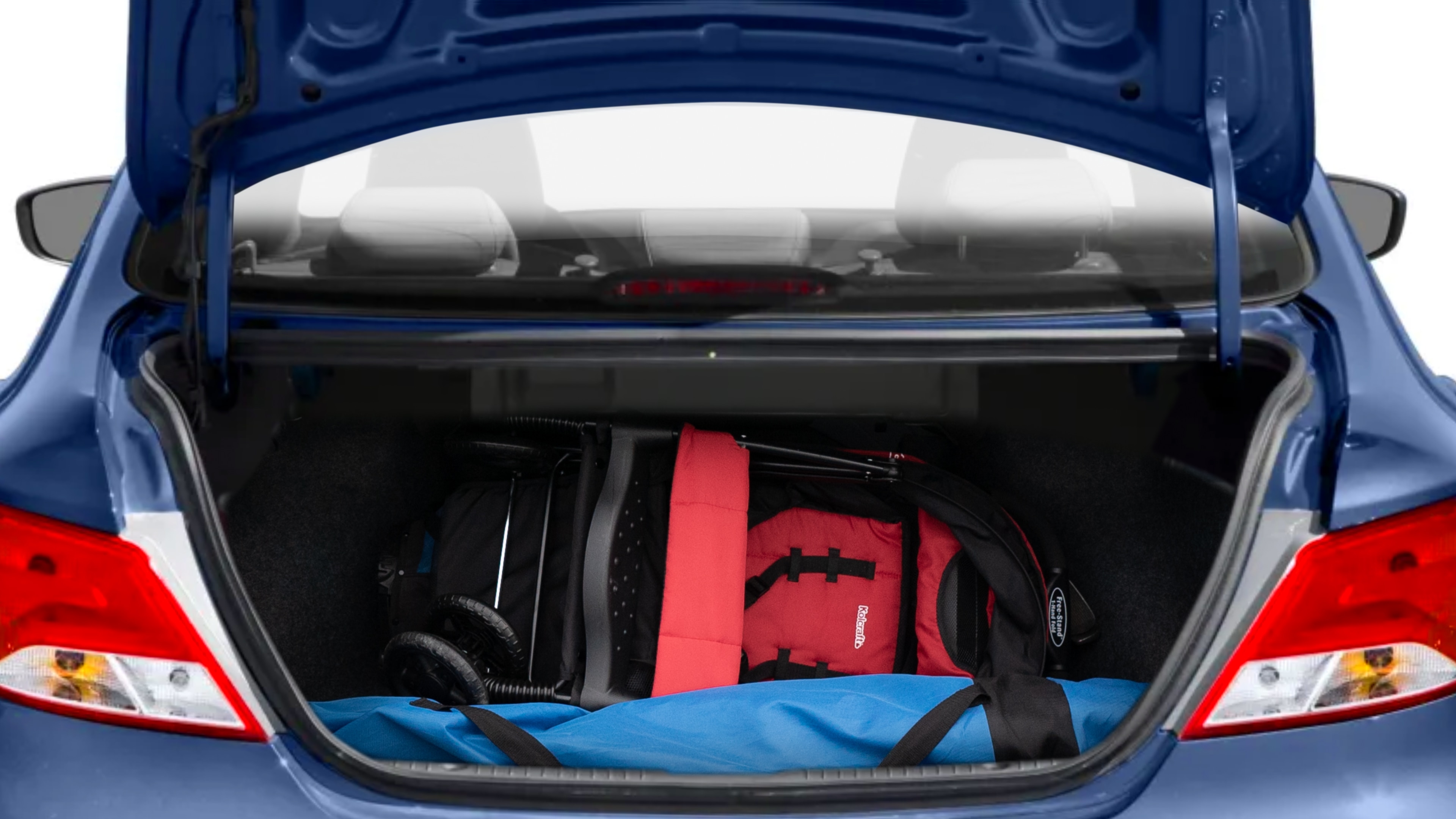 The trunk lid is open showing full view of the trunk. A baby stroller, three grocery carriers, two camping chairs in the carrying bag, and a set of golf clubs are placed inside.