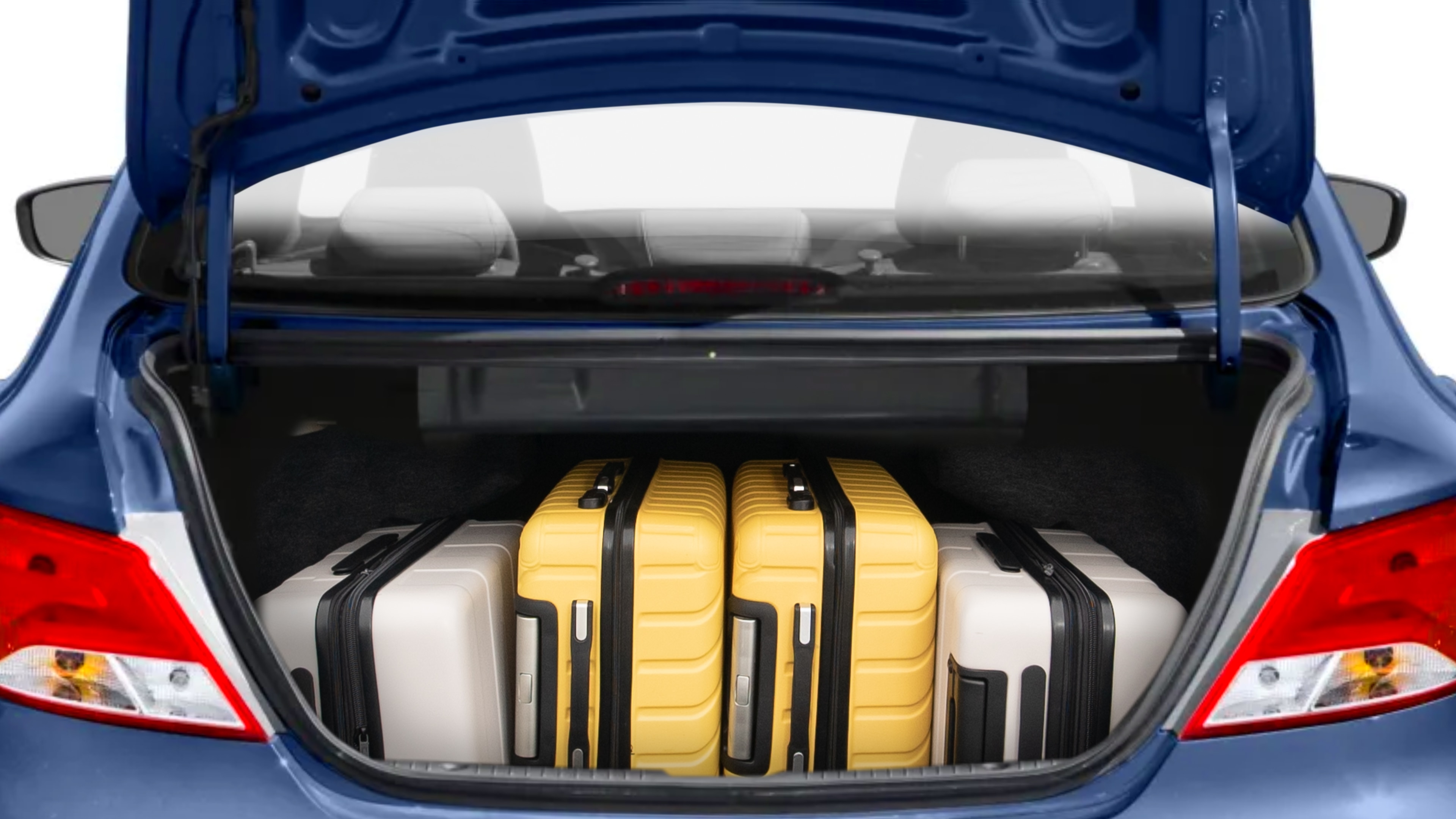 The trunk lid is open, showing full view of the trunk space. Two medium and two small suitcases are placed inside.