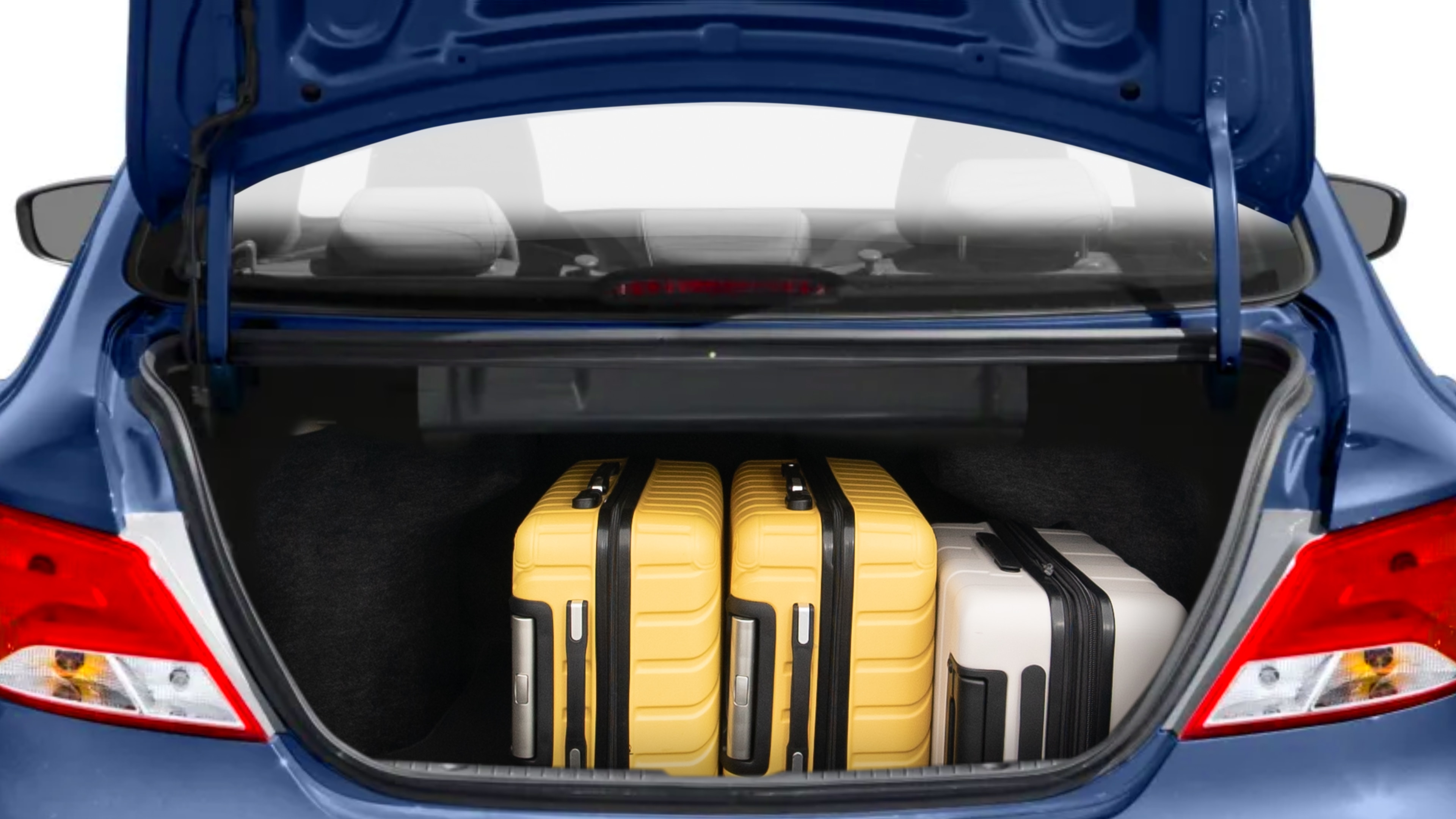 The trunk lid is open, showing full view of the trunk space. Two medium and two small suitcases are placed inside.