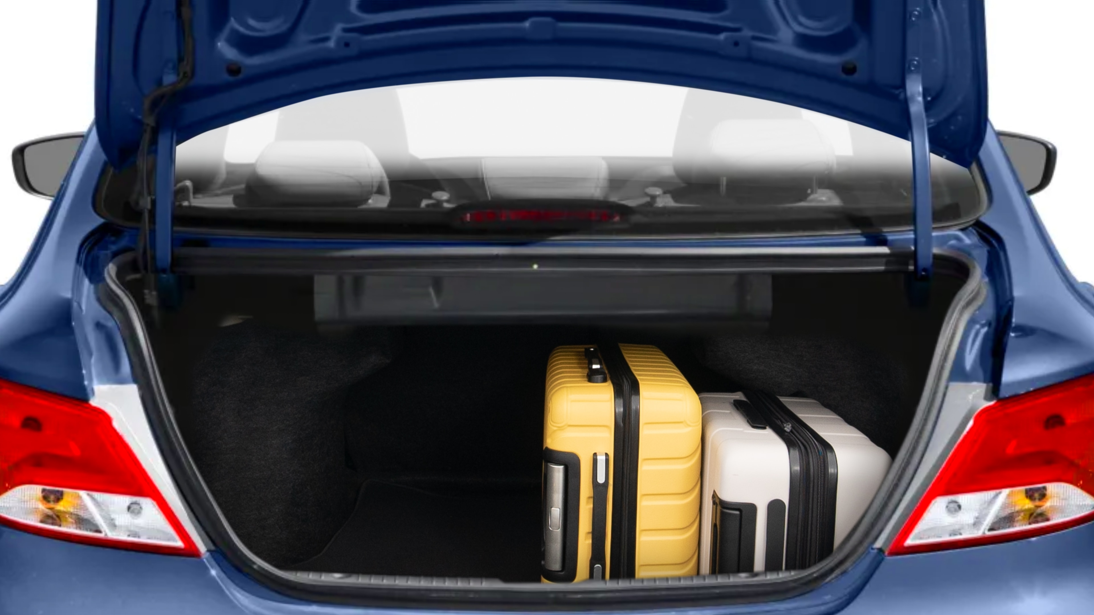 The trunk lid is open, showing full view of the trunk space. Two medium and two small suitcases are placed inside.