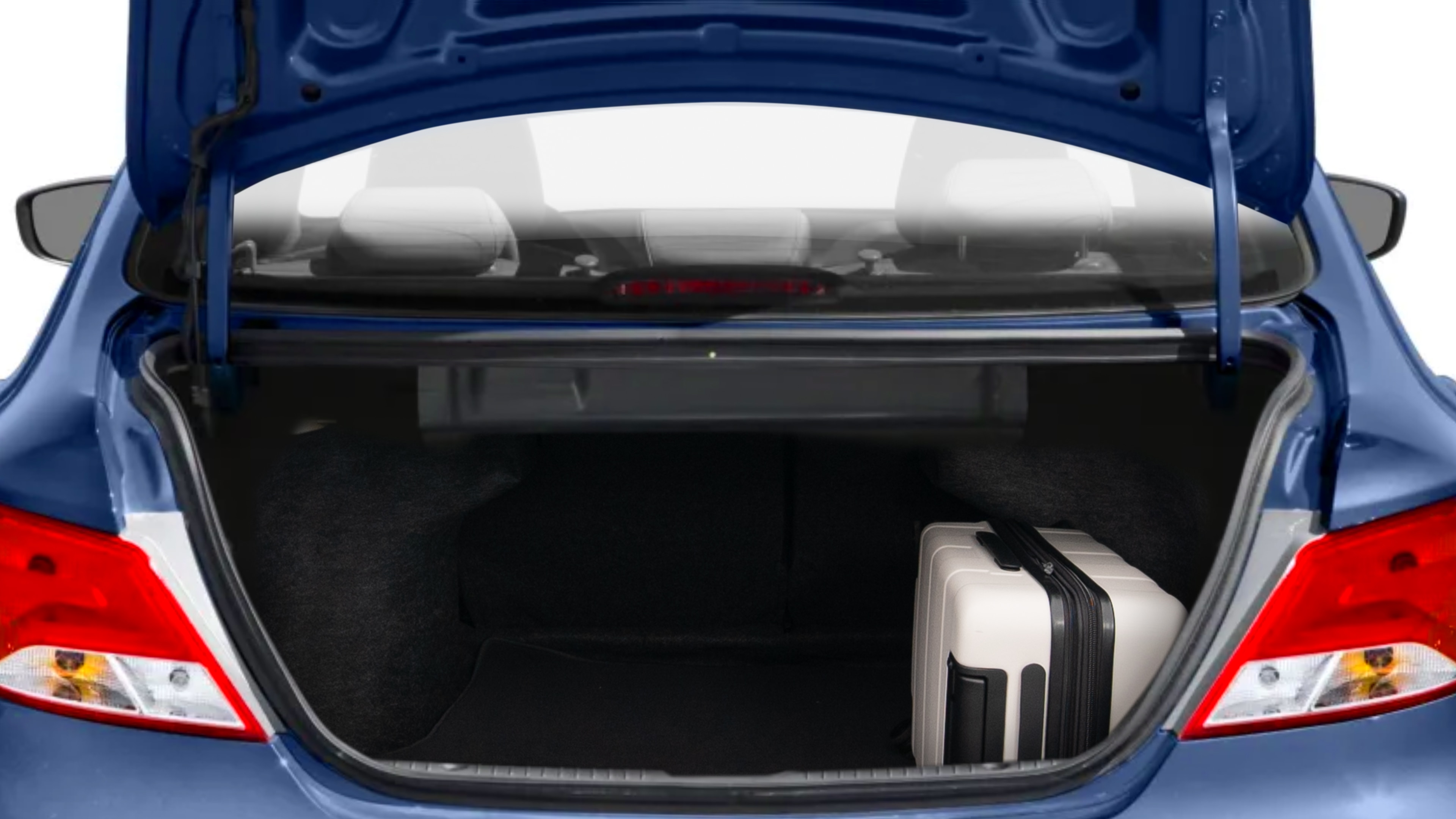 The trunk lid is open, showing full view of the trunk space. Two medium and two small suitcases are placed inside.