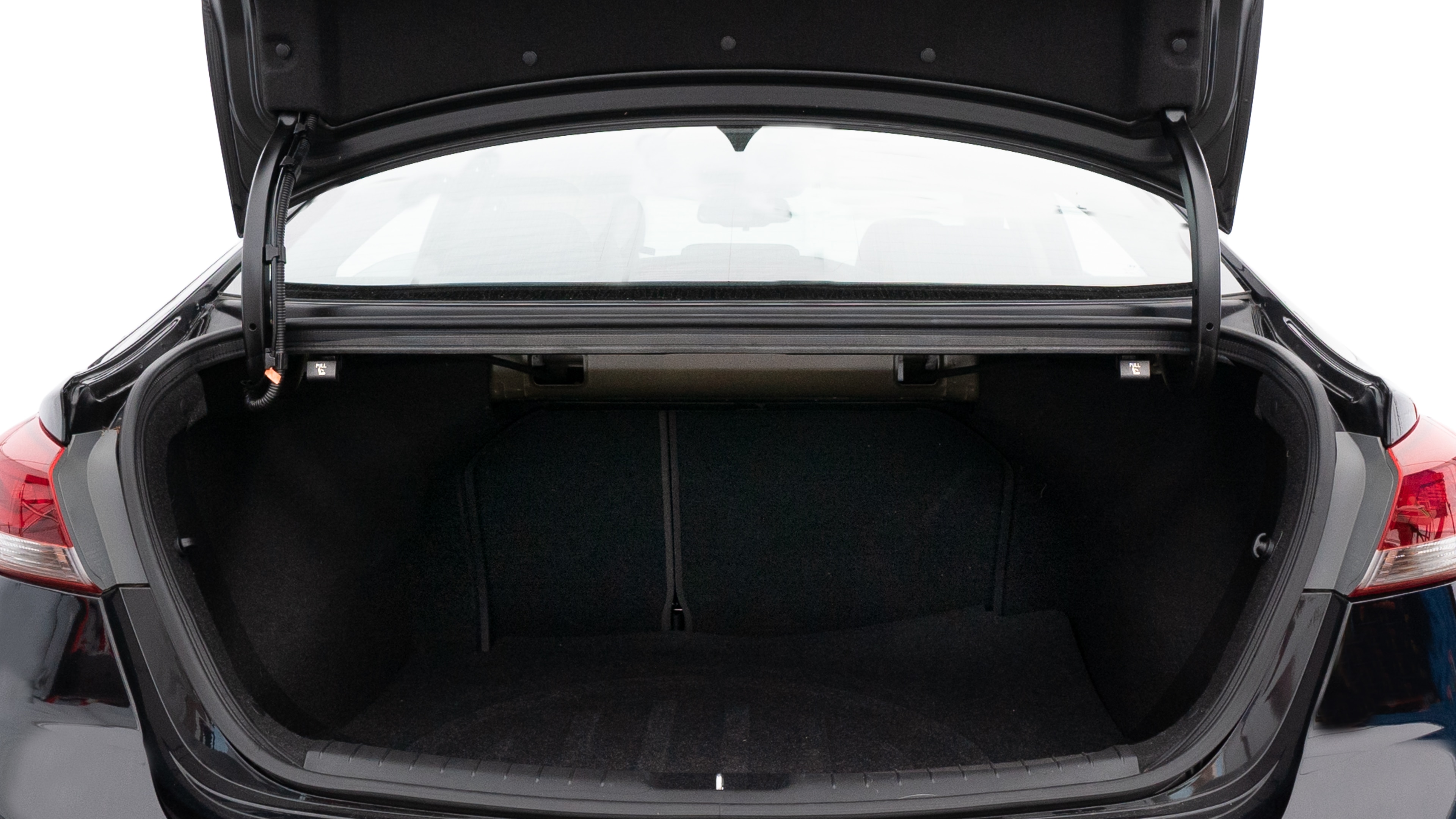 The trunk lid is open showing full view of the trunk. A baby stroller, three grocery carriers, two camping chairs in the carrying bag, and a set of golf clubs are placed inside.