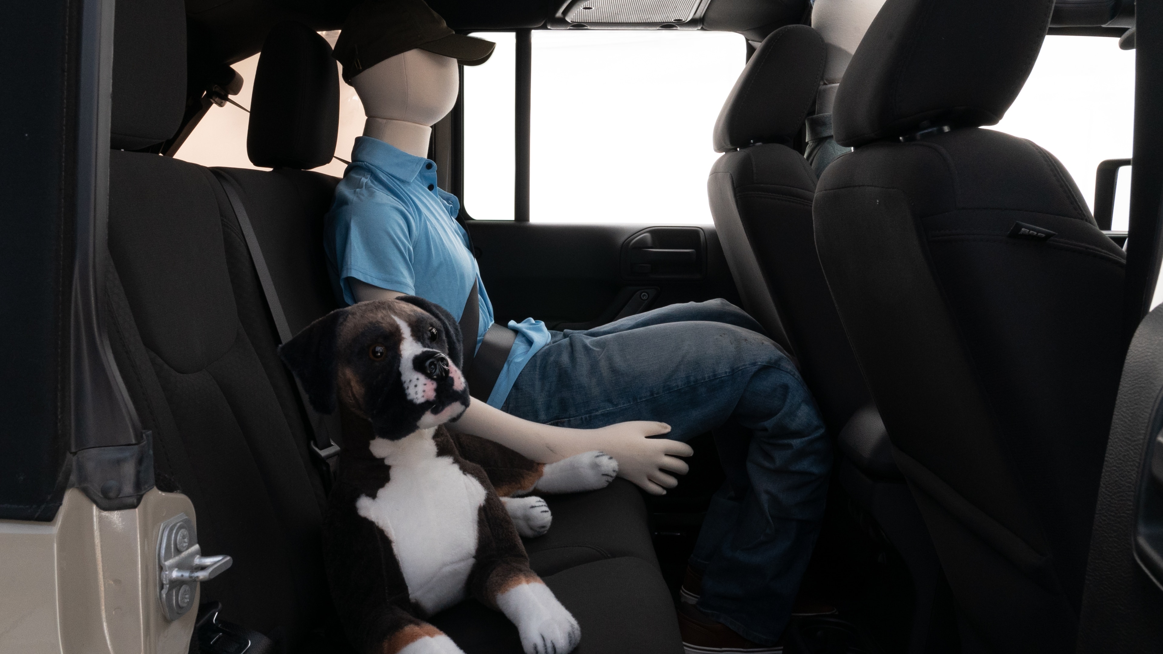 A series of second-row backseat photos is shown including one seating a baby seat and one seating a 6'1" mannequin.