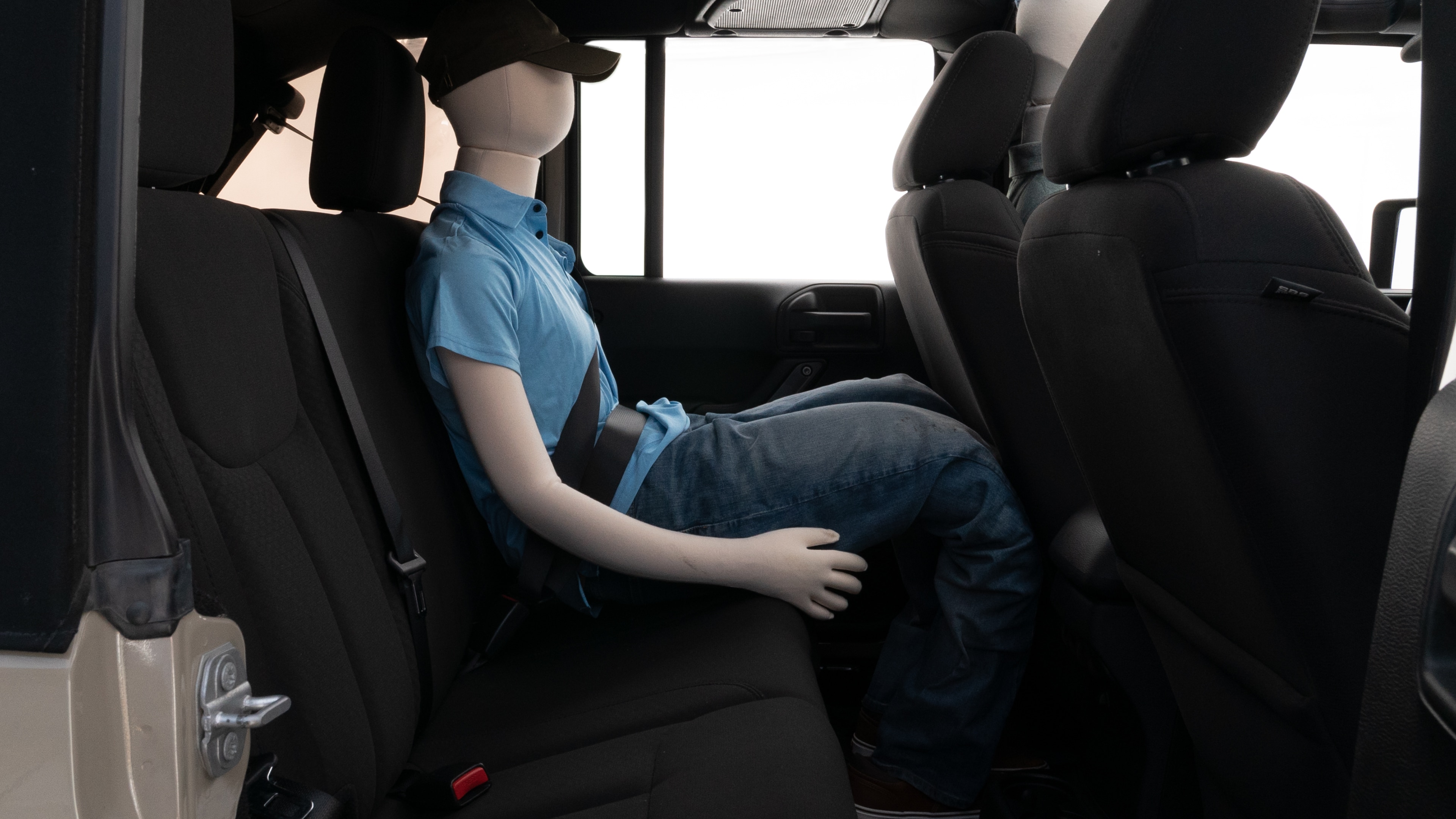 A series of second-row backseat photos is shown including one seating a baby seat and one seating a 6'1" mannequin.