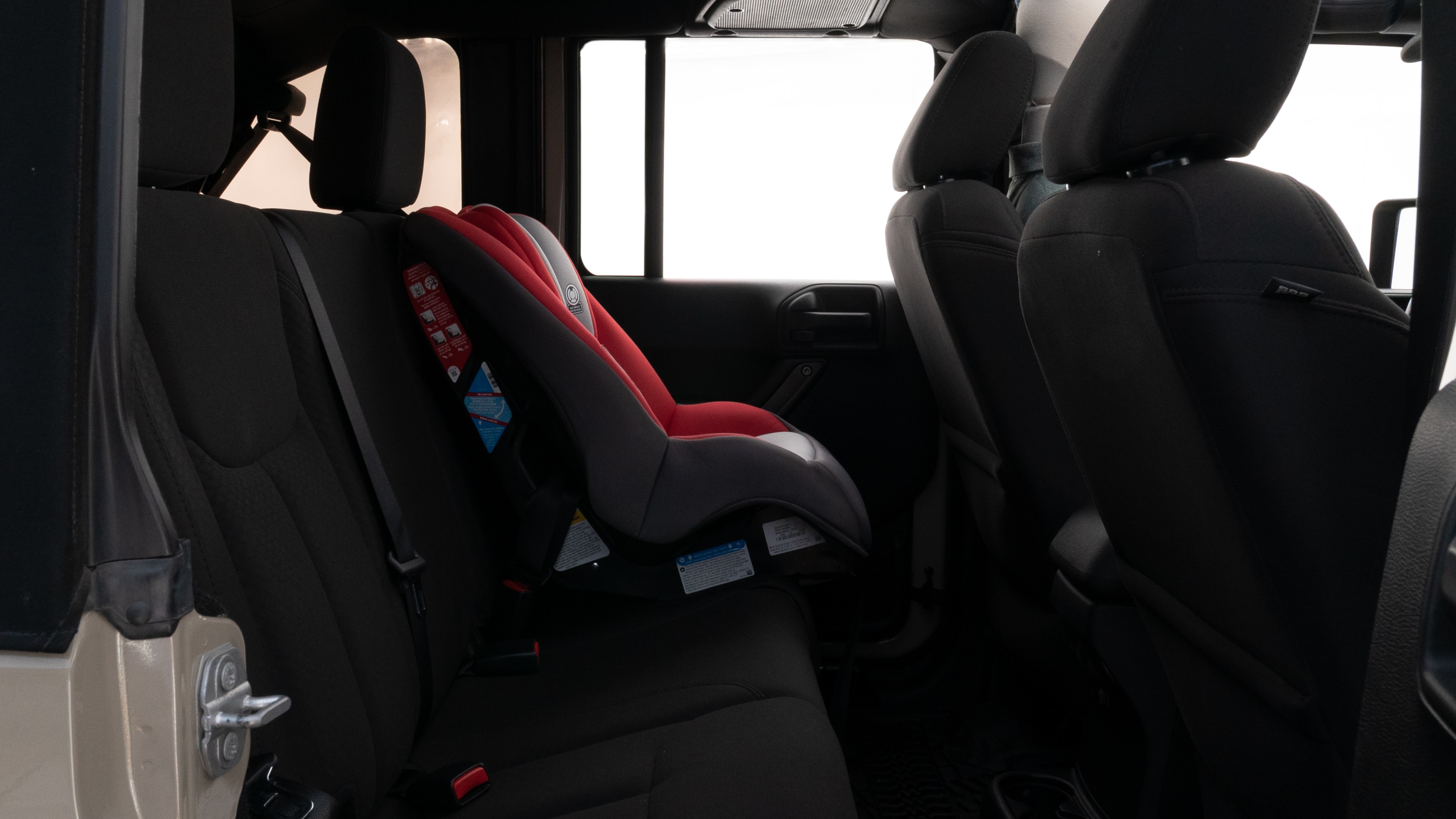 A series of second-row backseat photos is shown including one seating a baby seat and one seating a 6'1" mannequin.