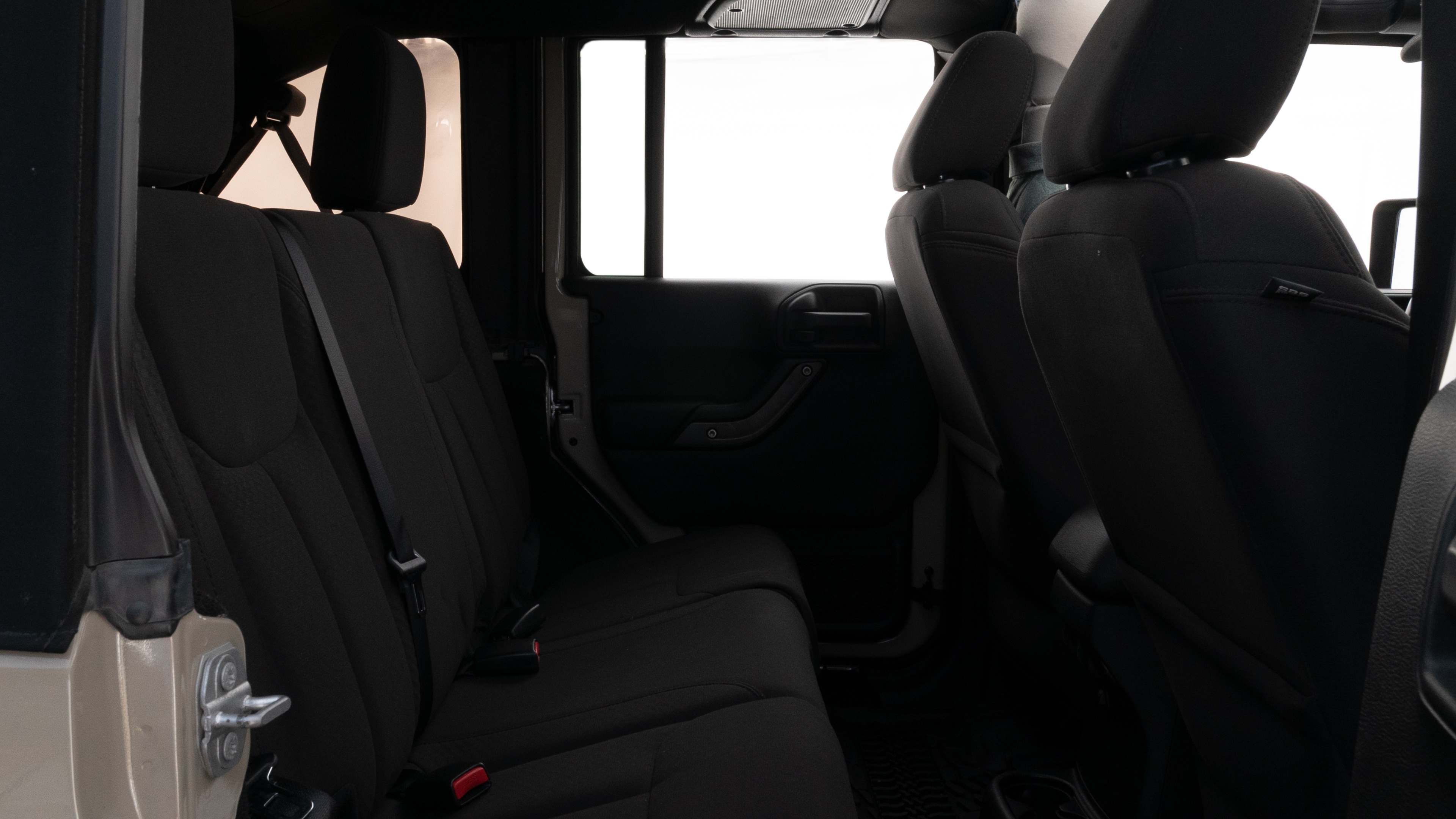 A series of second-row backseat photos is shown including one seating a baby seat and one seating a 6'1" mannequin.