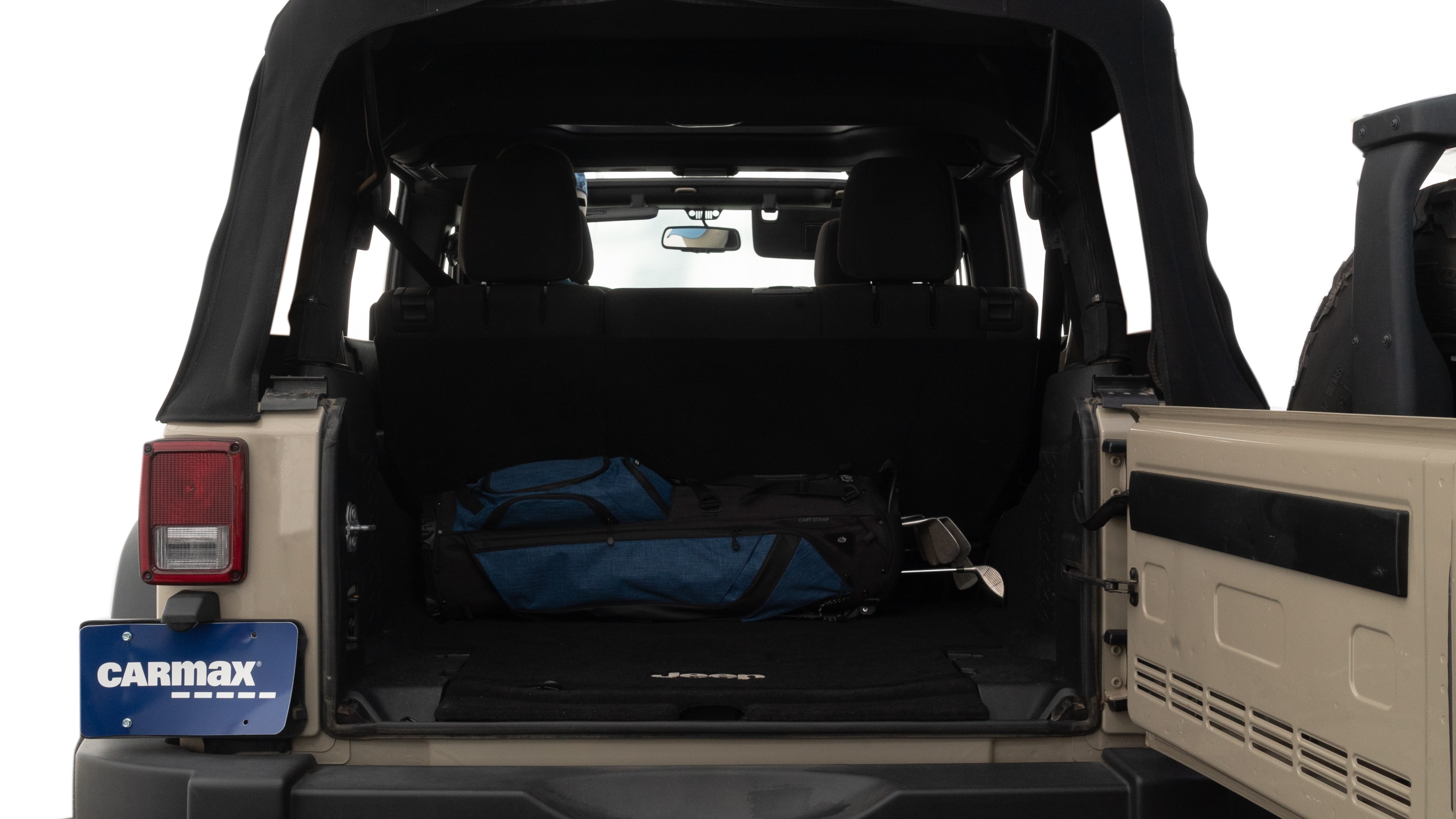 The trunk lid is open showing full view of the trunk. A baby stroller, three grocery carriers, two camping chairs in the carrying bag, and a set of golf clubs are placed inside.