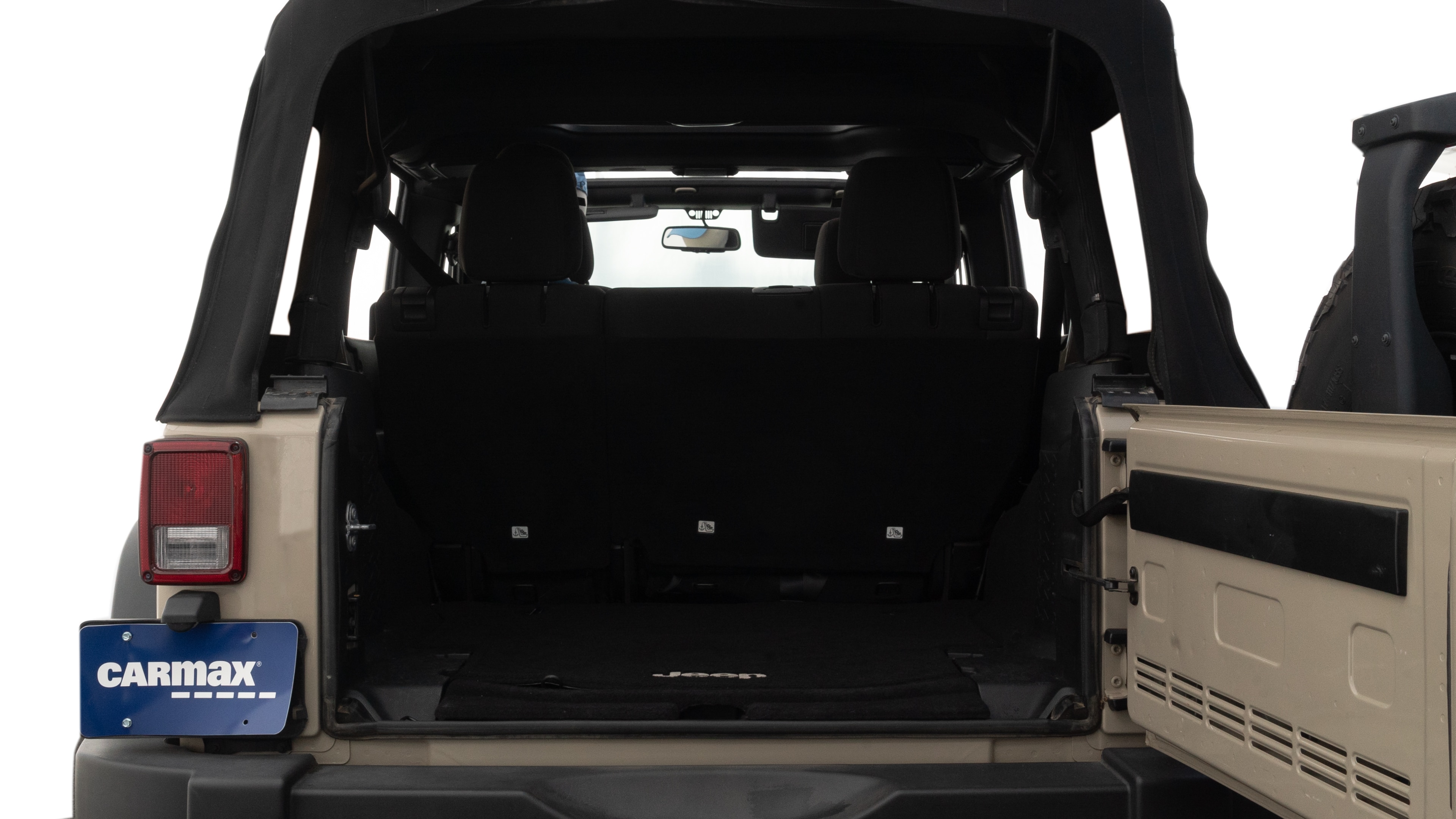 The trunk lid is open, showing full view of the trunk space. One large, two medium, and one small suitcases are placed inside.
