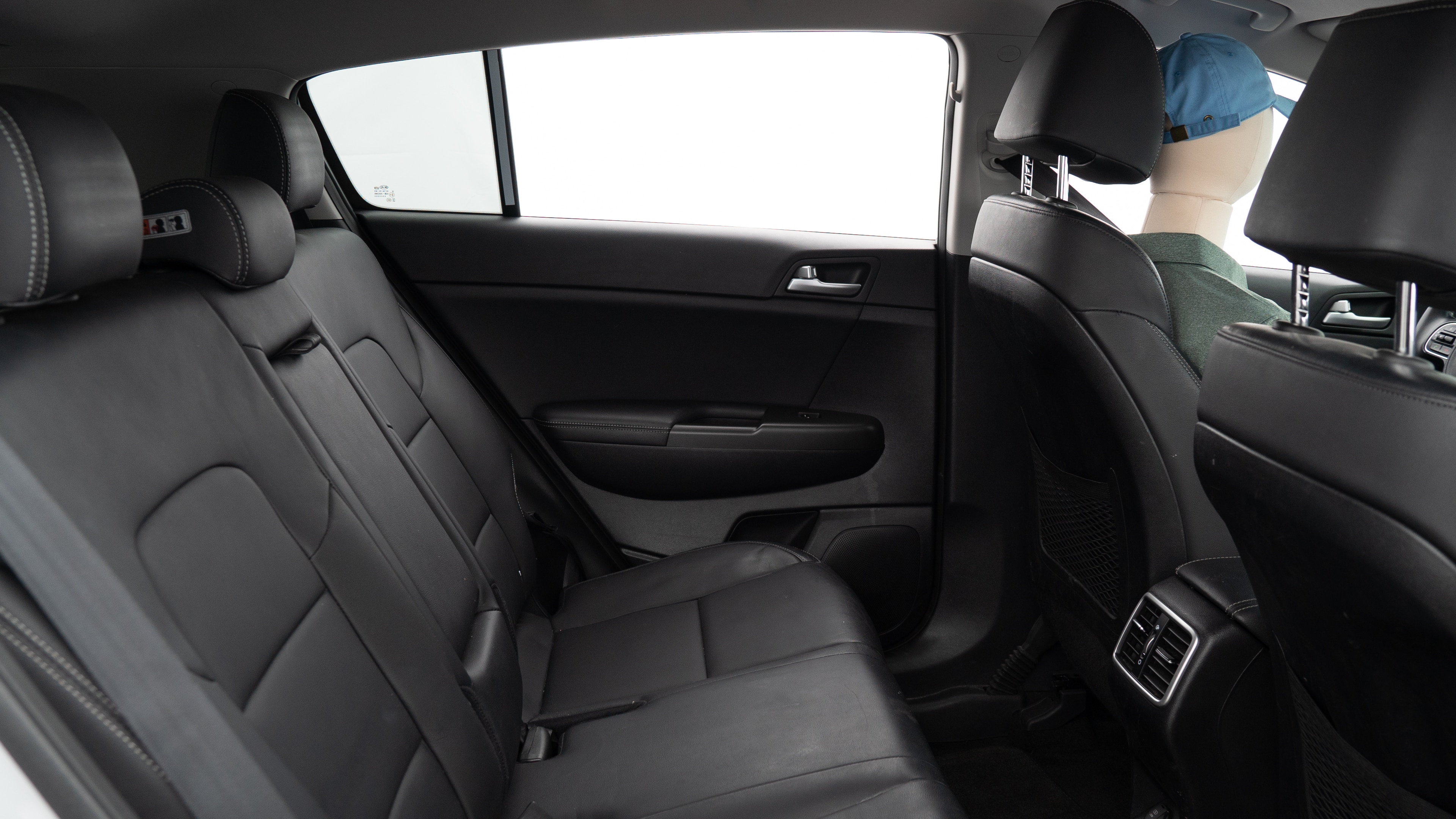 A series of second-row backseat photos is shown including one seating a baby seat, a dog and one seating a 6'1" mannequin.