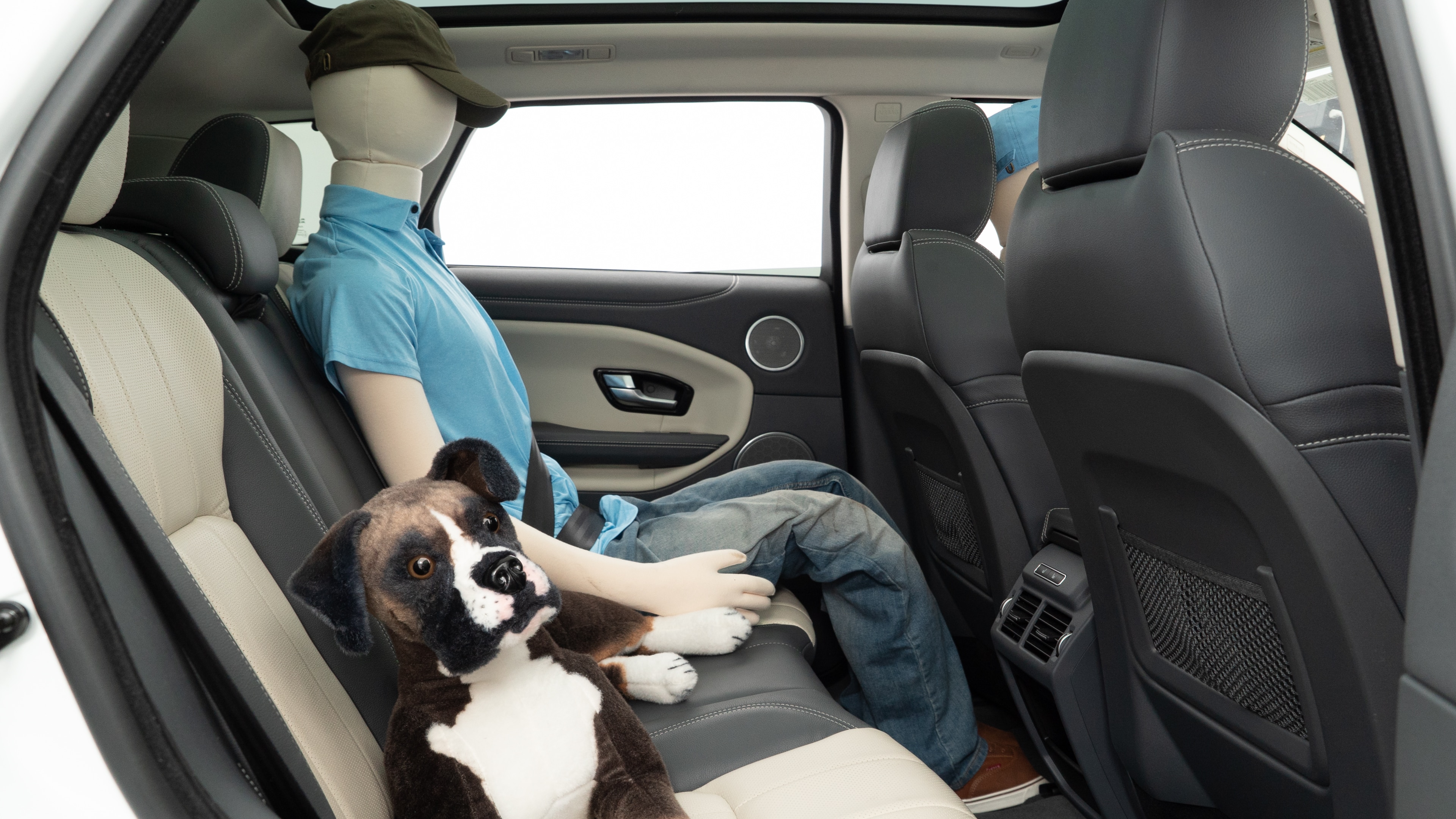 A series of second-row backseat photos is shown including one seating a baby seat and one seating a 6'1" mannequin.
