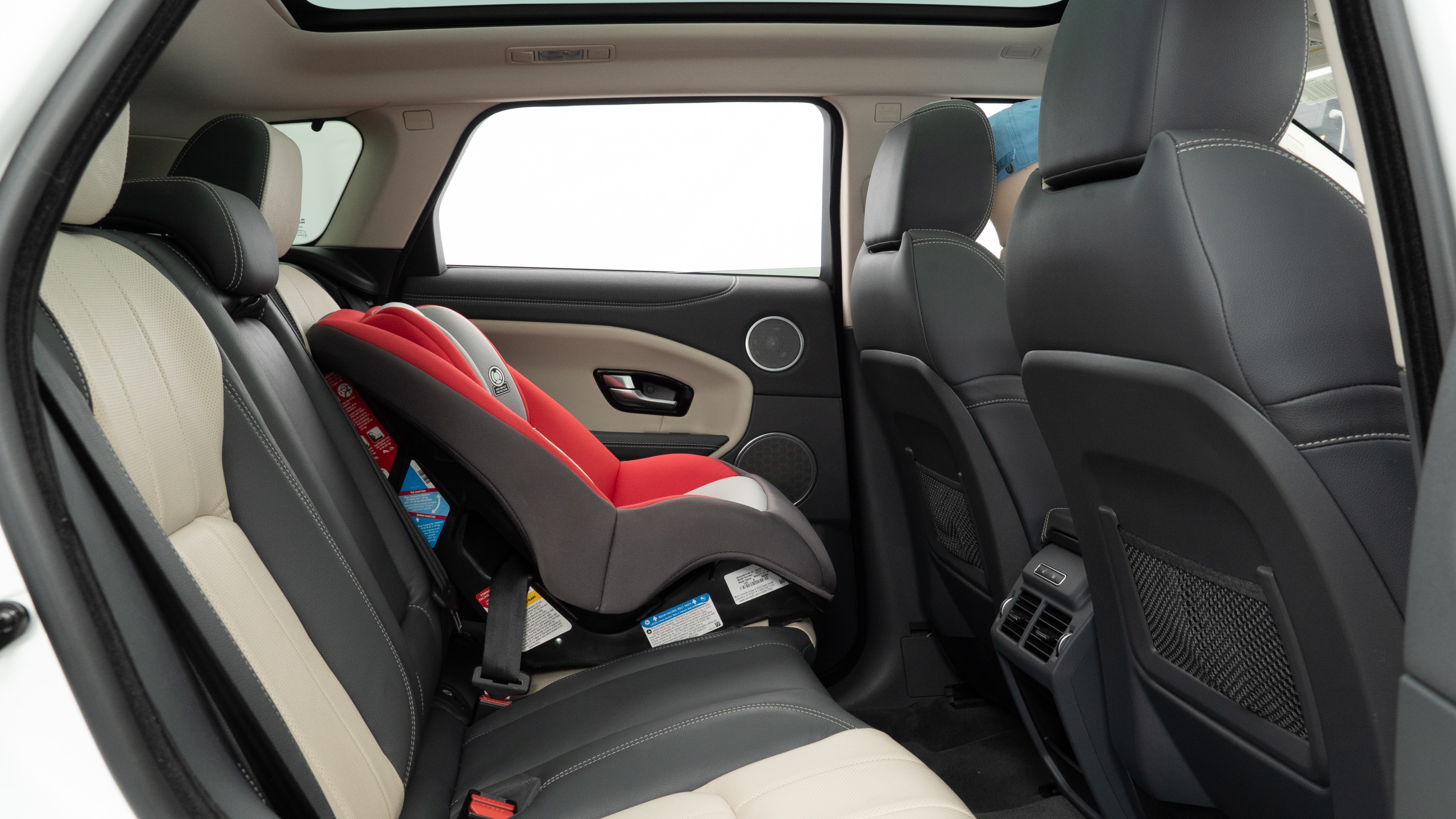 A series of second-row backseat photos is shown including one seating a baby seat and one seating a 6'1" mannequin.