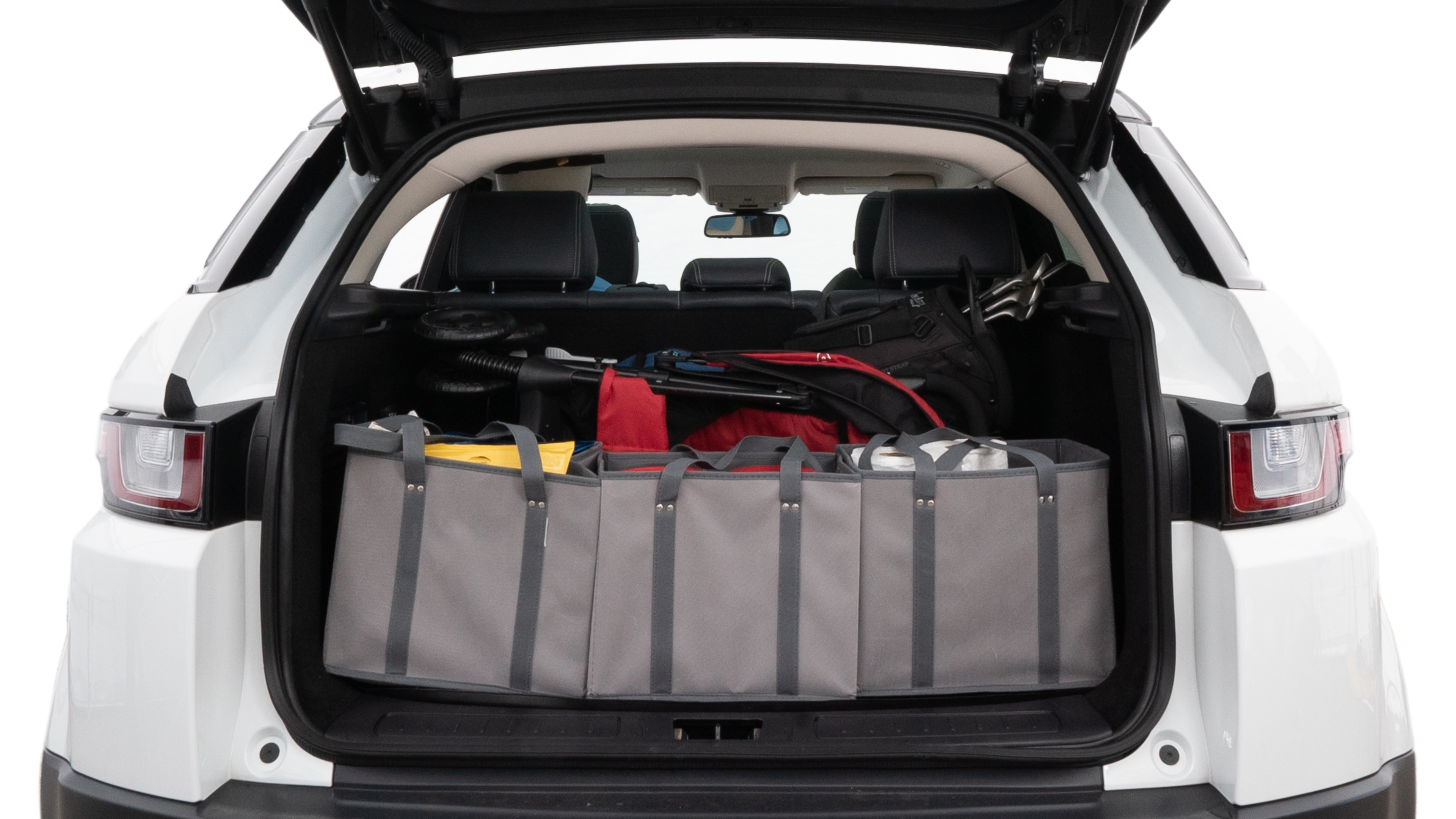 The trunk lid is open showing full view of the trunk. A baby stroller, three grocery carriers, two camping chairs in the carrying bag, and a set of golf clubs are placed inside.