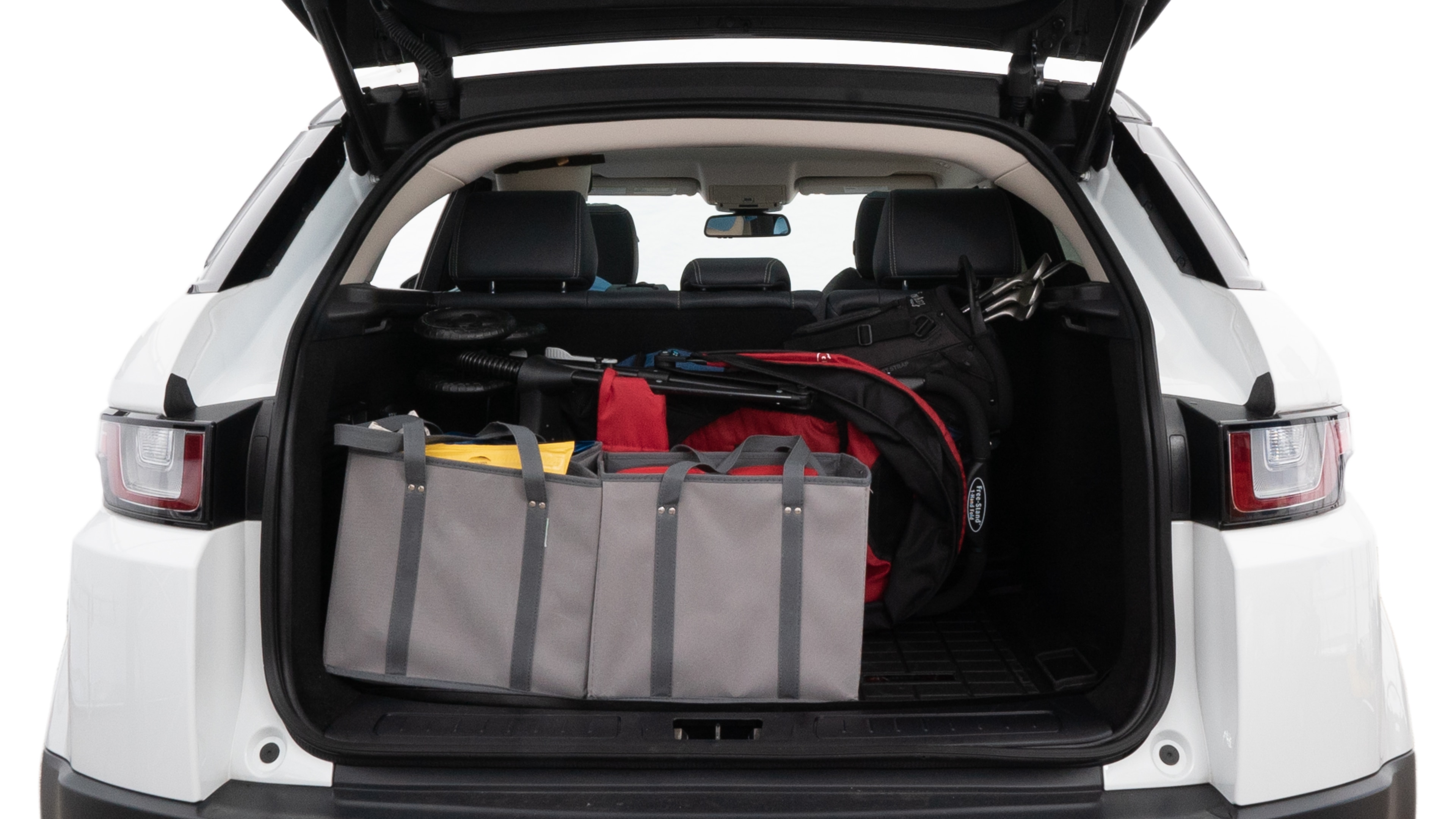 The trunk lid is open showing full view of the trunk. A baby stroller, three grocery carriers, two camping chairs in the carrying bag, and a set of golf clubs are placed inside.