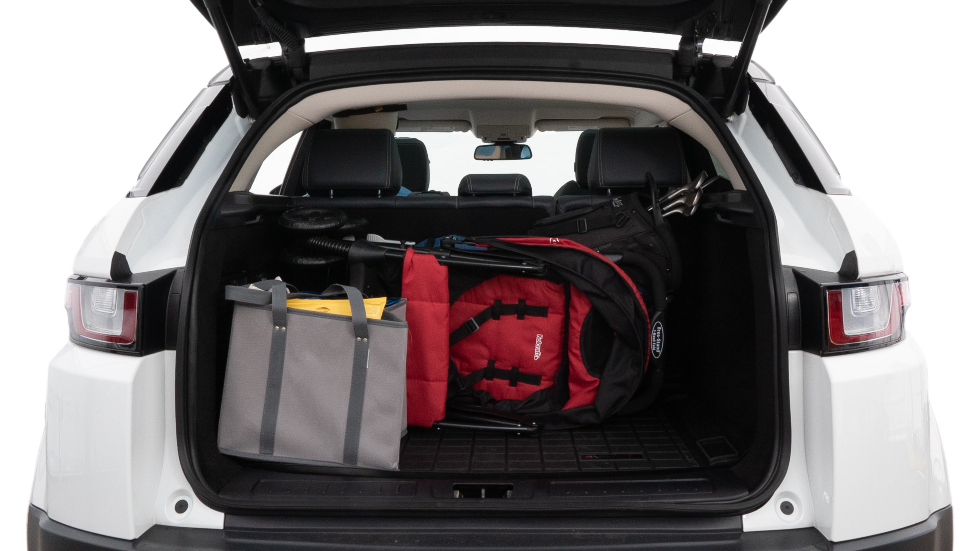 The trunk lid is open showing full view of the trunk. A baby stroller, three grocery carriers, two camping chairs in the carrying bag, and a set of golf clubs are placed inside.