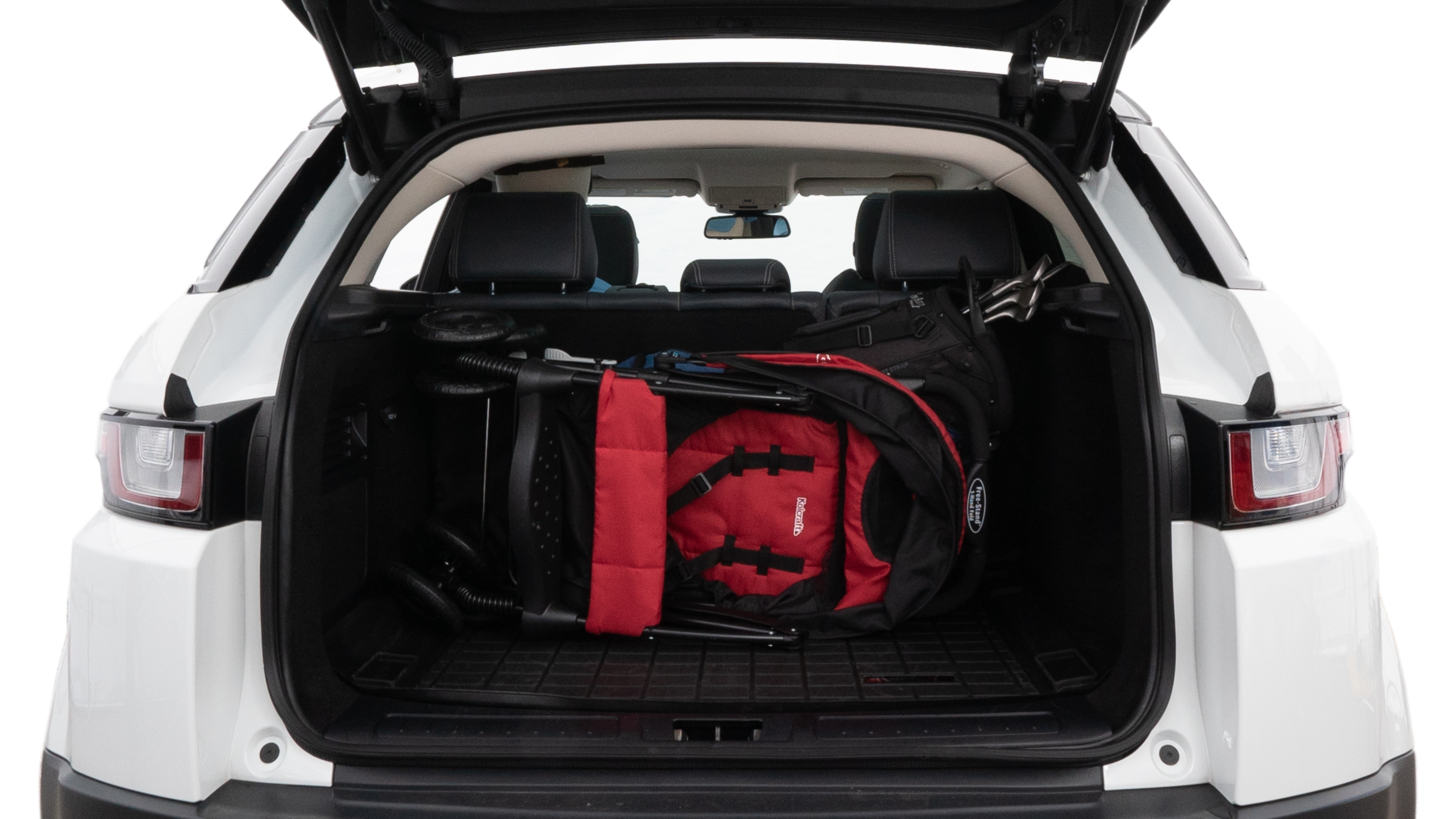 The trunk lid is open showing full view of the trunk. A baby stroller, three grocery carriers, two camping chairs in the carrying bag, and a set of golf clubs are placed inside.