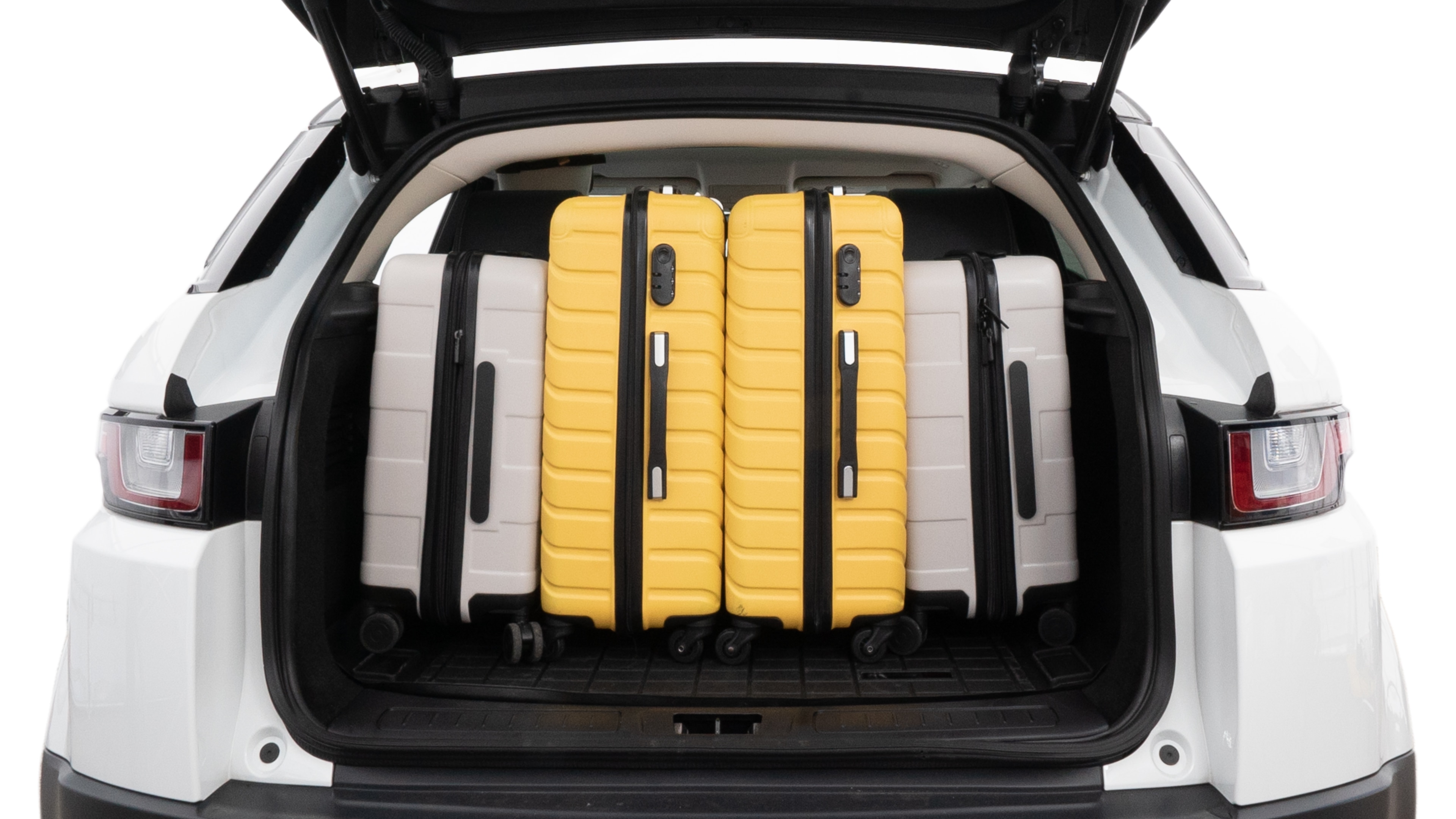 The trunk lid is open, showing full view of the trunk space. Two medium and two small suitcases are placed inside.