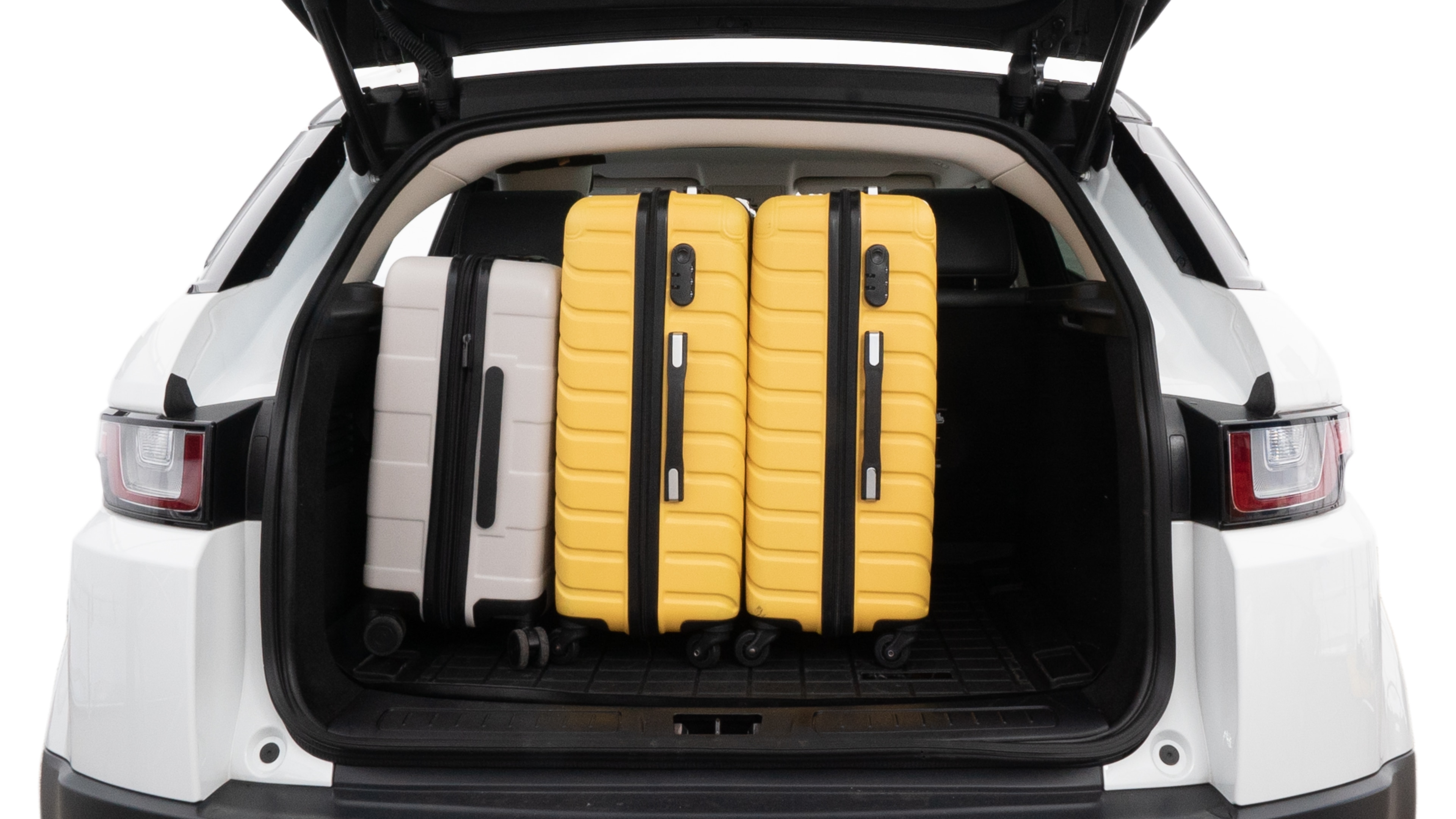 The trunk lid is open, showing full view of the trunk space. Two medium and two small suitcases are placed inside.