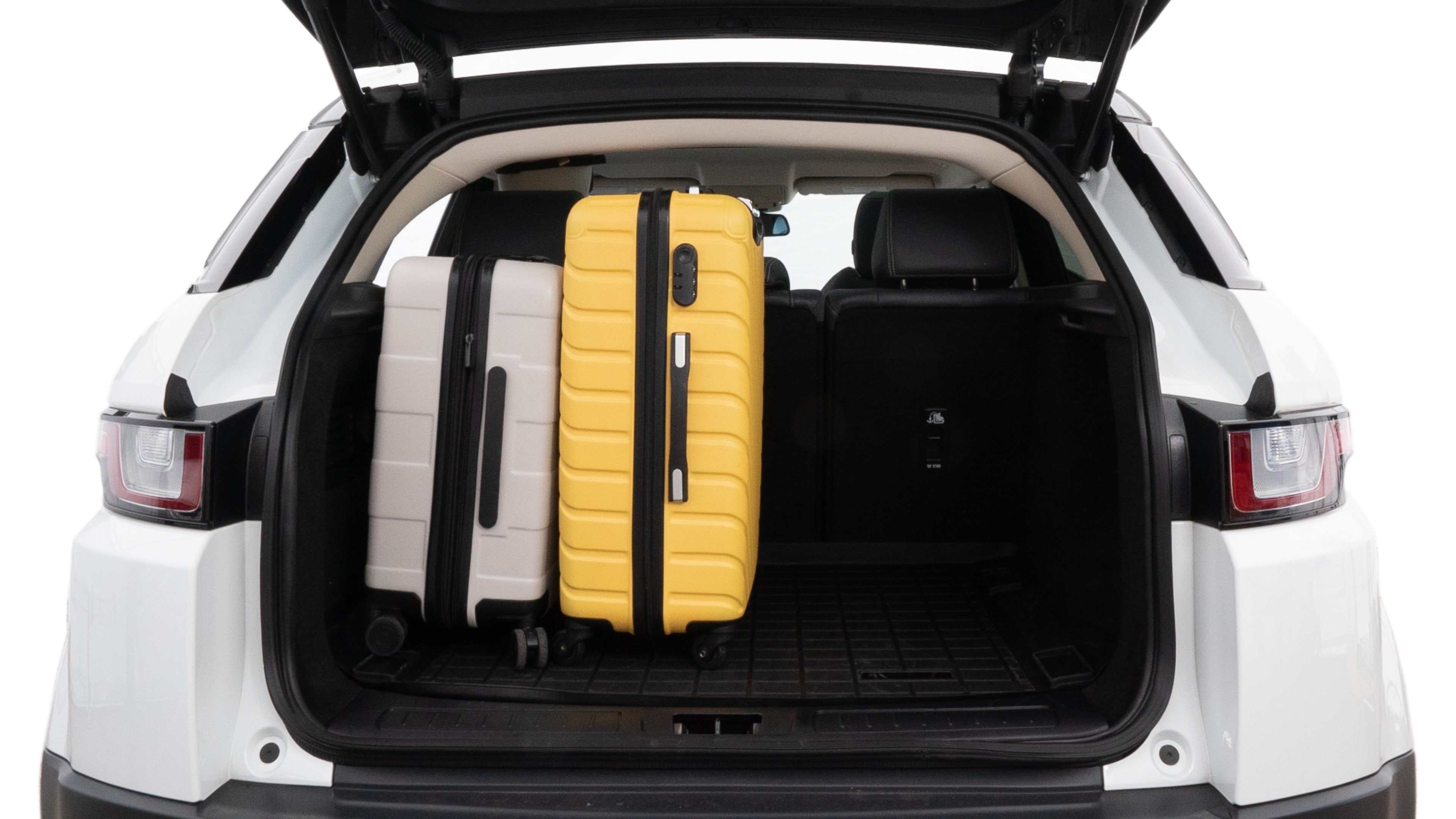 The trunk lid is open, showing full view of the trunk space. Two medium and two small suitcases are placed inside.