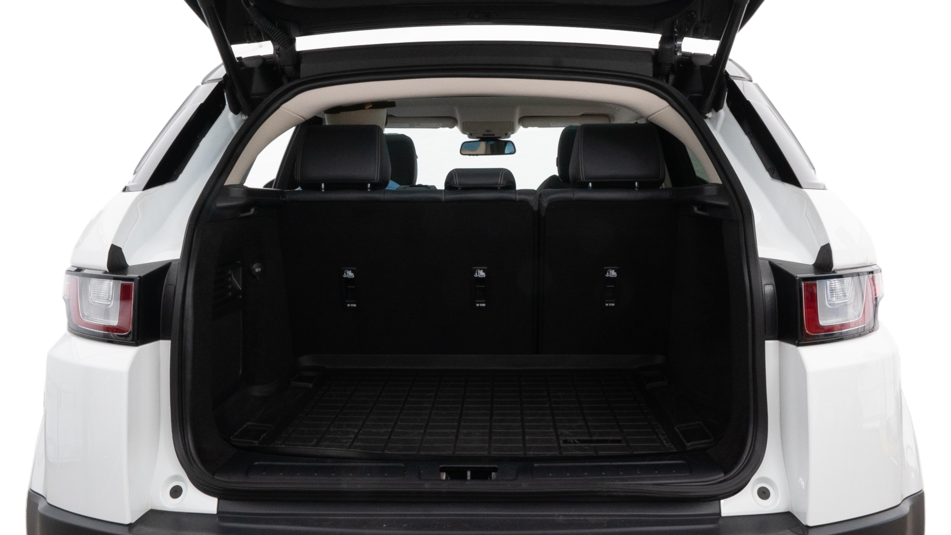 The trunk lid is open, showing full view of the trunk space. Two medium and two small suitcases are placed inside.