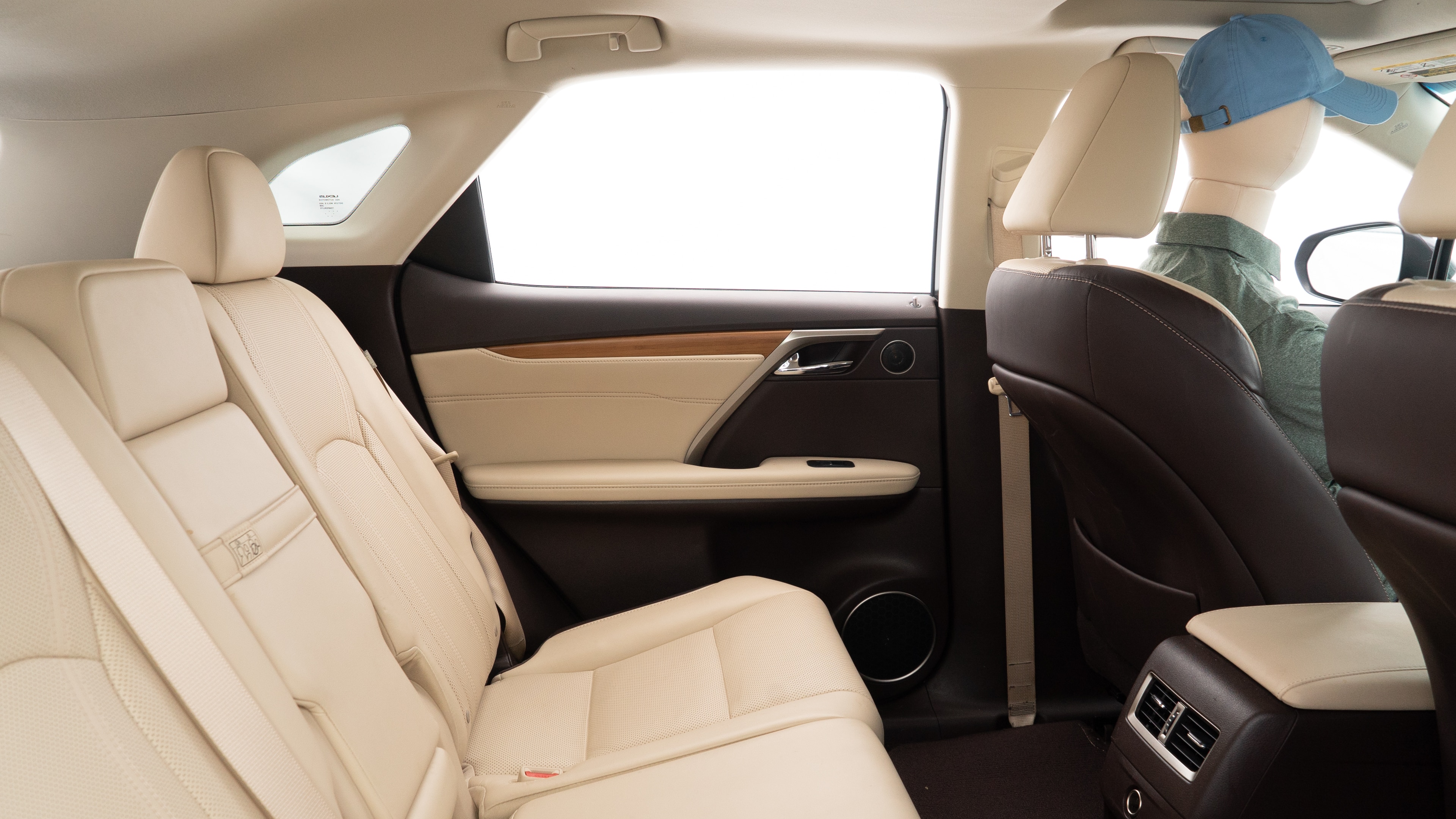 A series of second-row backseat photos is shown including one seating a baby seat and one seating a 6'1" mannequin.