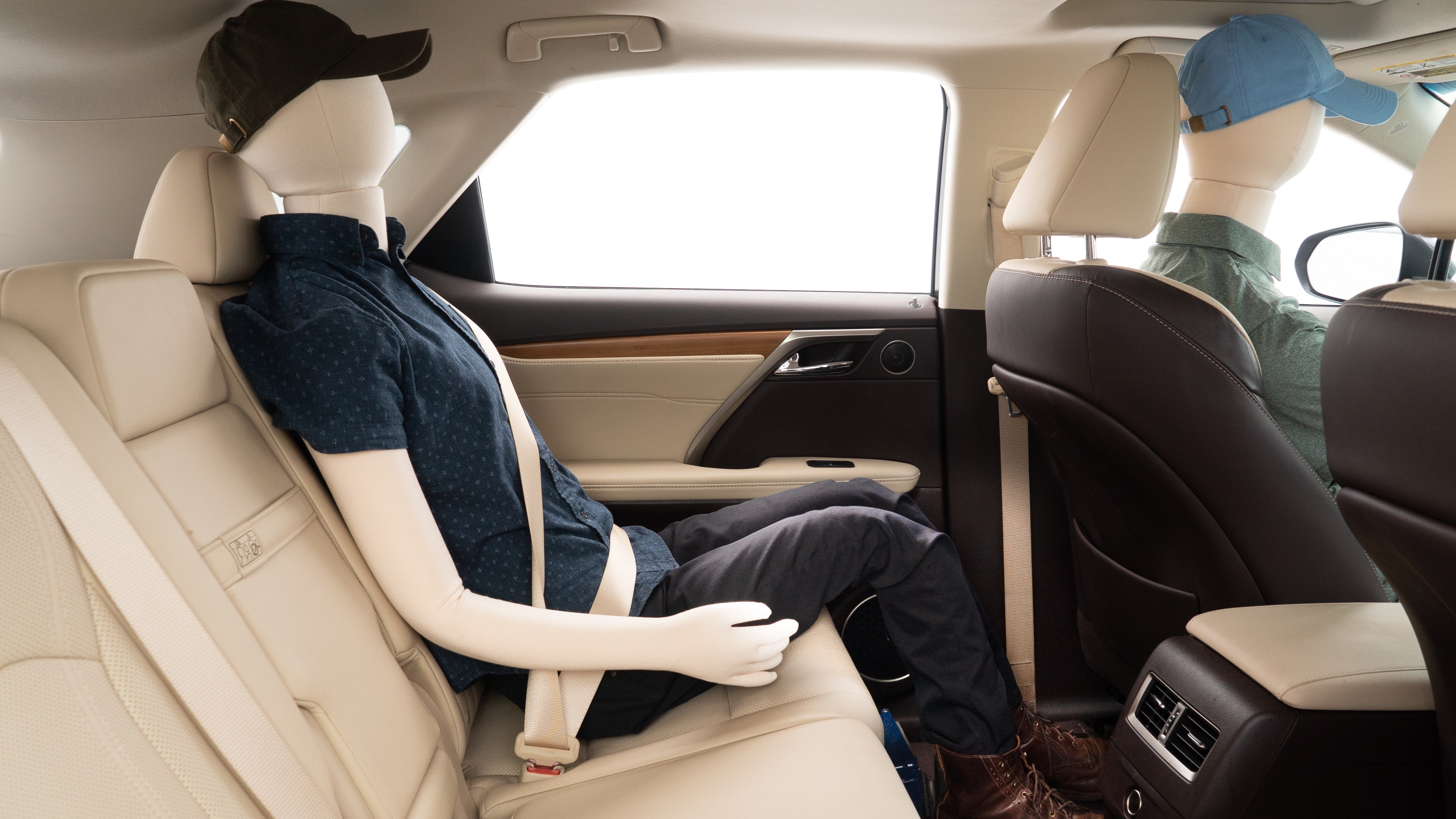 A series of second-row backseat photos is shown including one seating a baby seat and one seating a 6'1" mannequin.