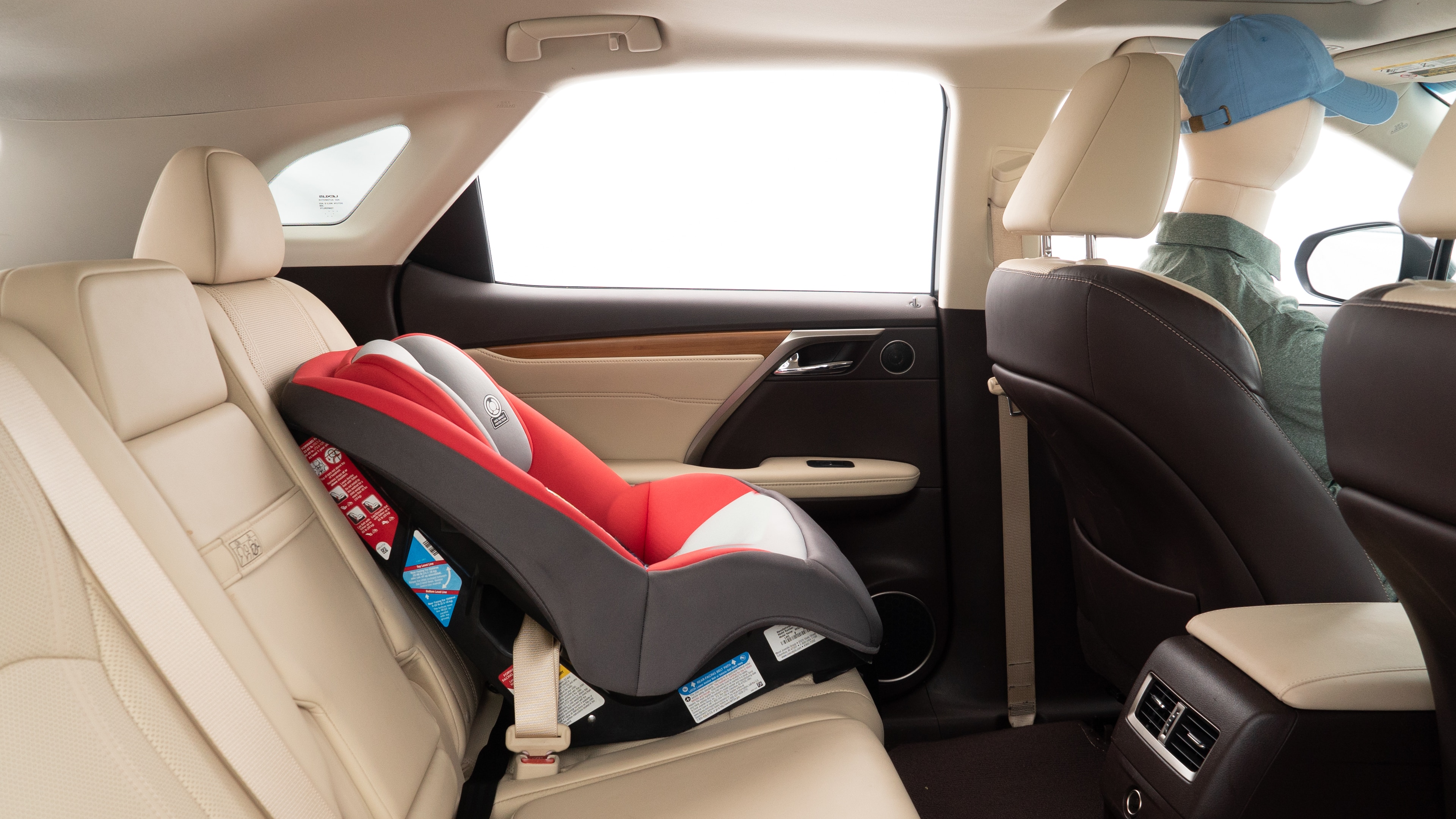 A series of second-row backseat photos is shown including one seating a baby seat and one seating a 6'1" mannequin.