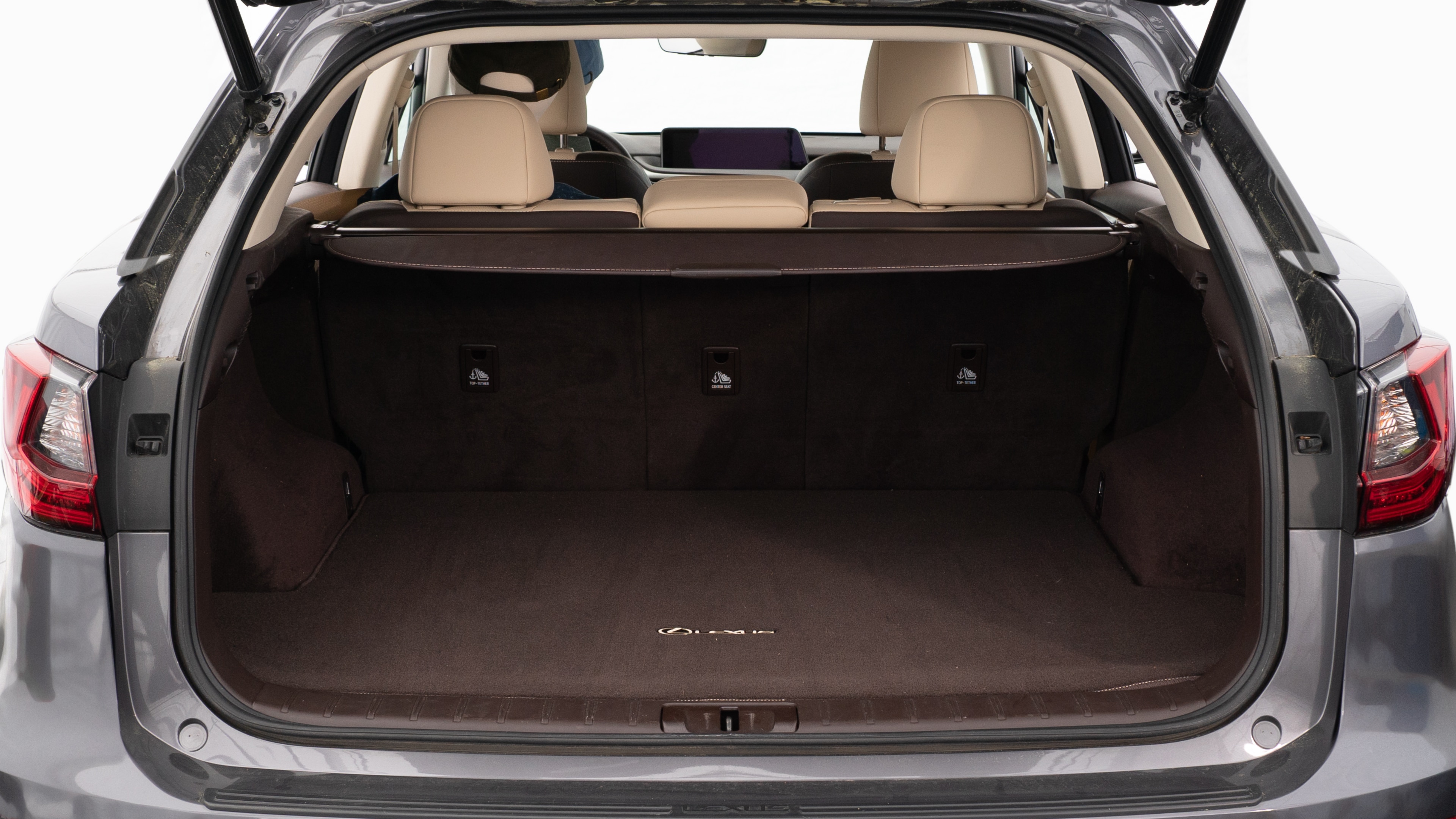 The trunk lid is open, showing a full view of the trunk space. Two large and two small suitcases are are placed inside.