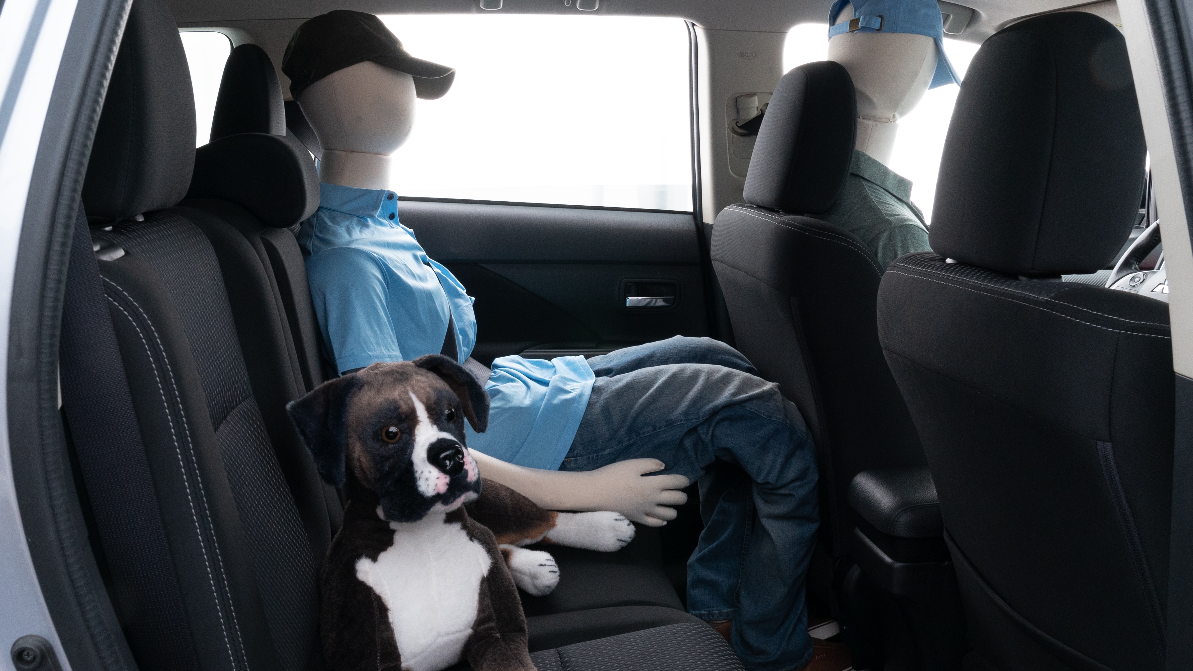 A series of second-row backseat photos is shown including one seating a baby seat and one seating a 6'1" mannequin.