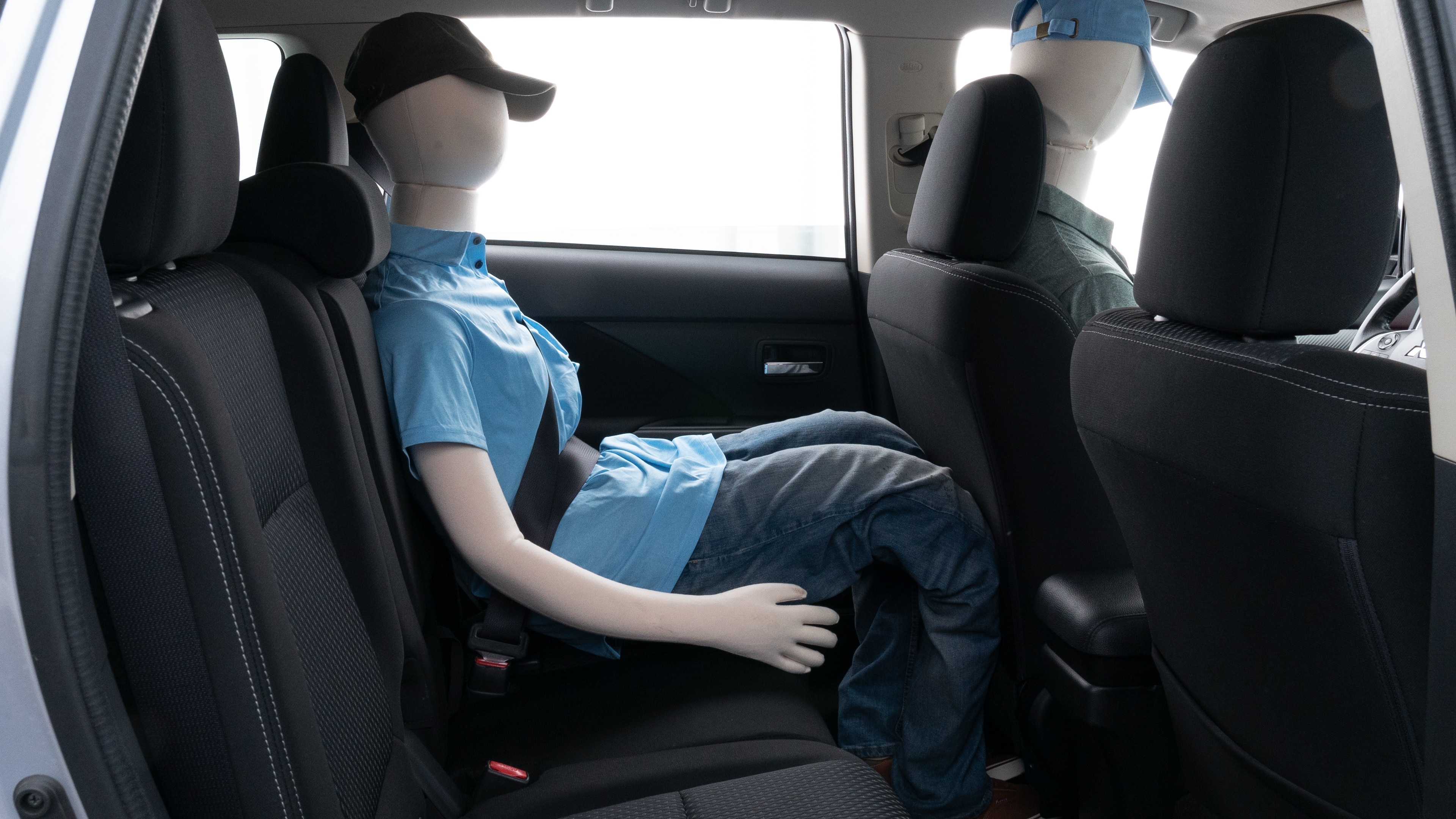A series of second-row backseat photos is shown including one seating a baby seat and one seating a 6'1" mannequin.