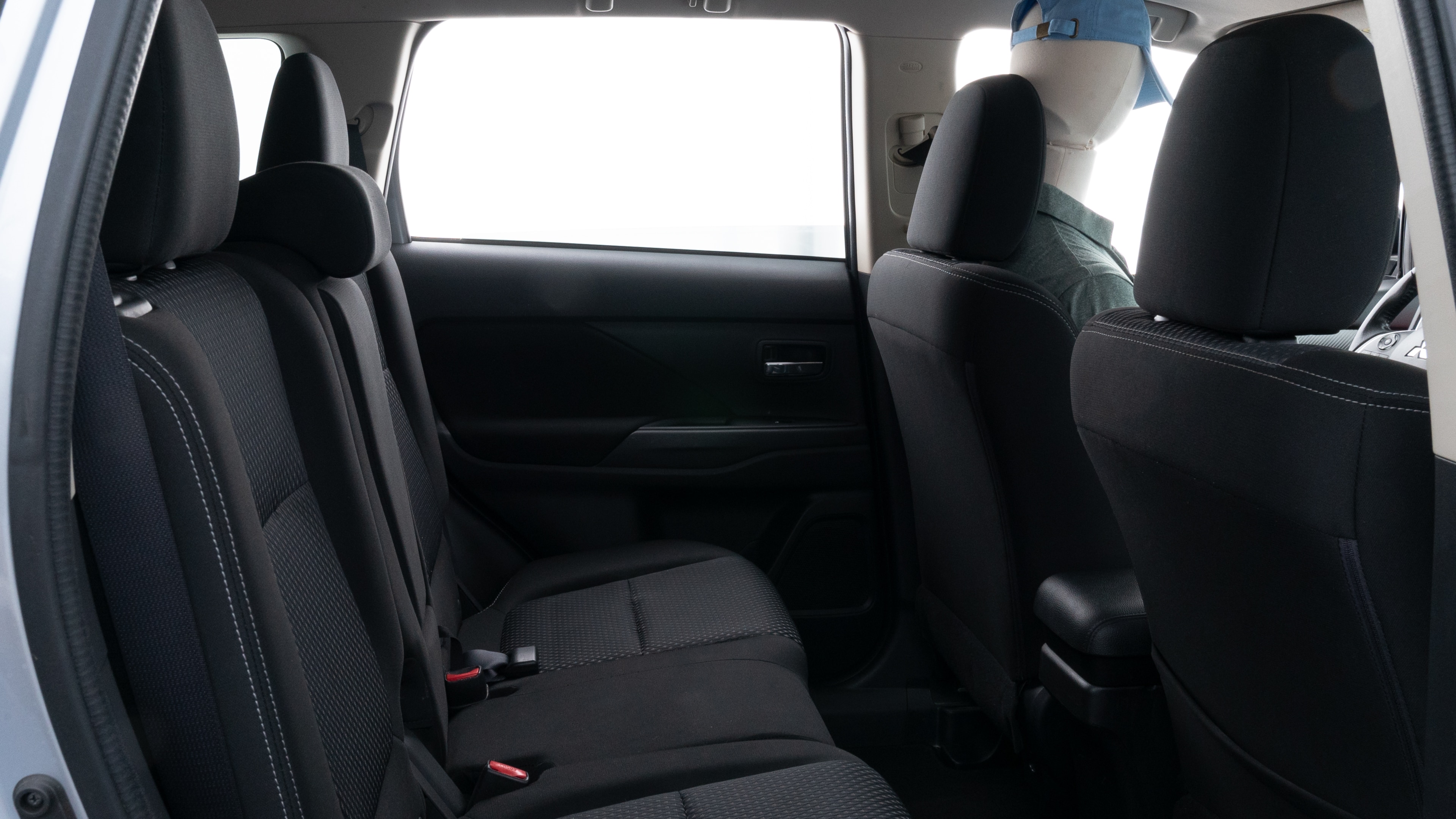 A series of second-row backseat photos is shown including one seating a baby seat and one seating a 6'1" mannequin.