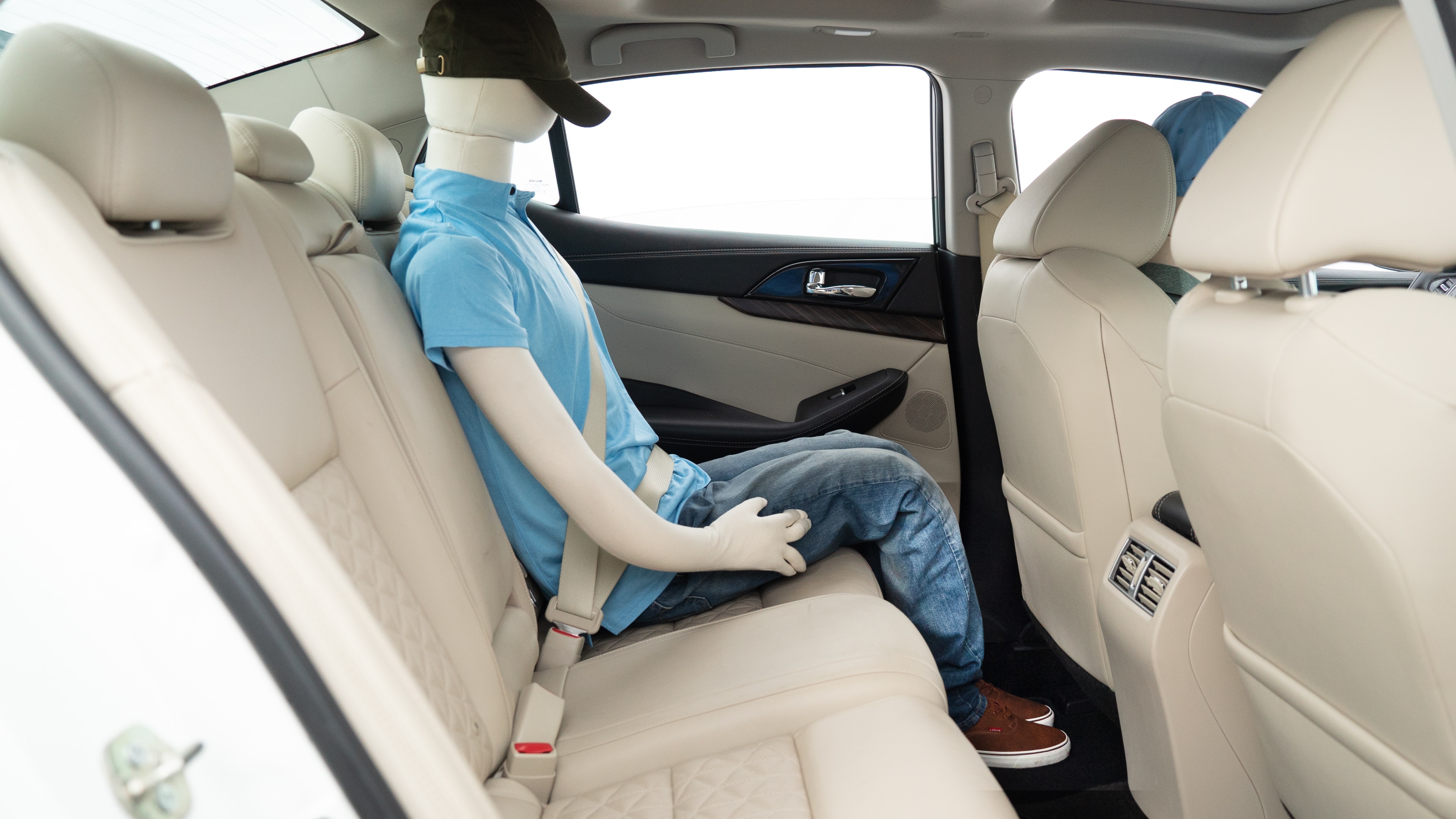 A series of second-row backseat photos is shown including one seating a baby seat, a dog and one seating a 6'1" mannequin.