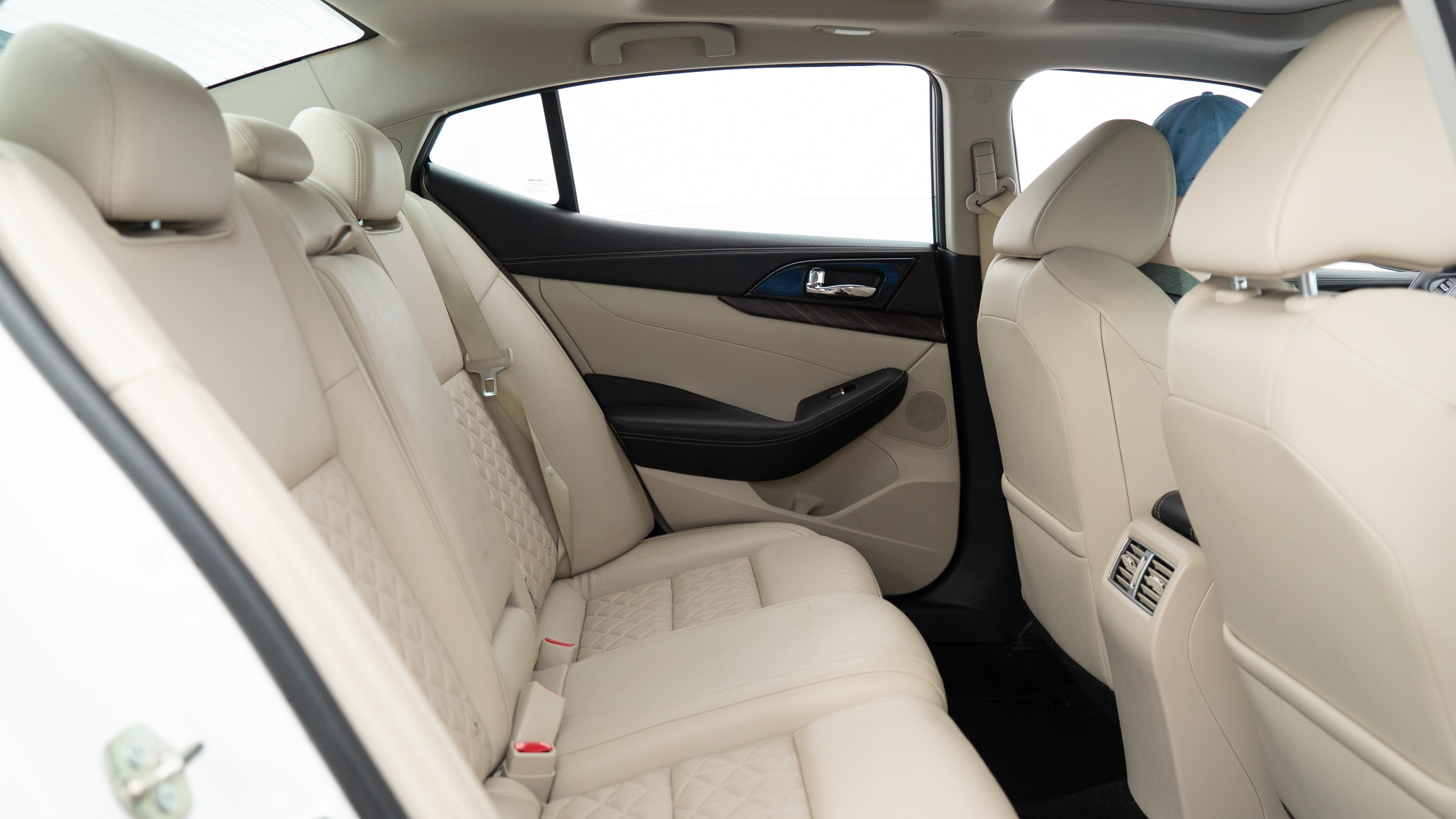A series of second-row backseat photos is shown including one seating a baby seat, a dog and one seating a 6'1" mannequin.