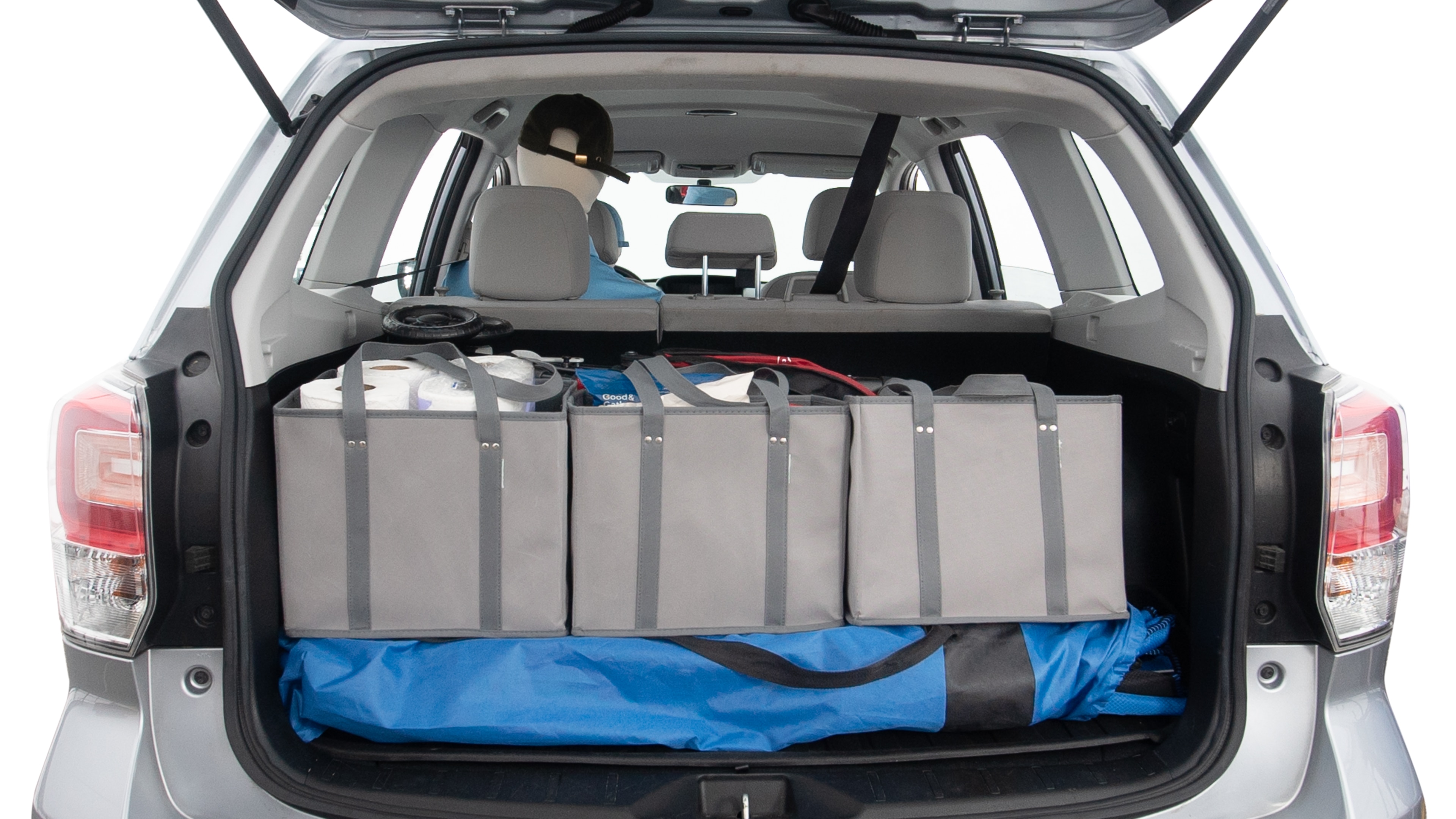 The trunk lid is open showing full view of the trunk. A baby stroller, three grocery carriers, two camping chairs in the carrying bag, and a set of golf clubs are placed inside.