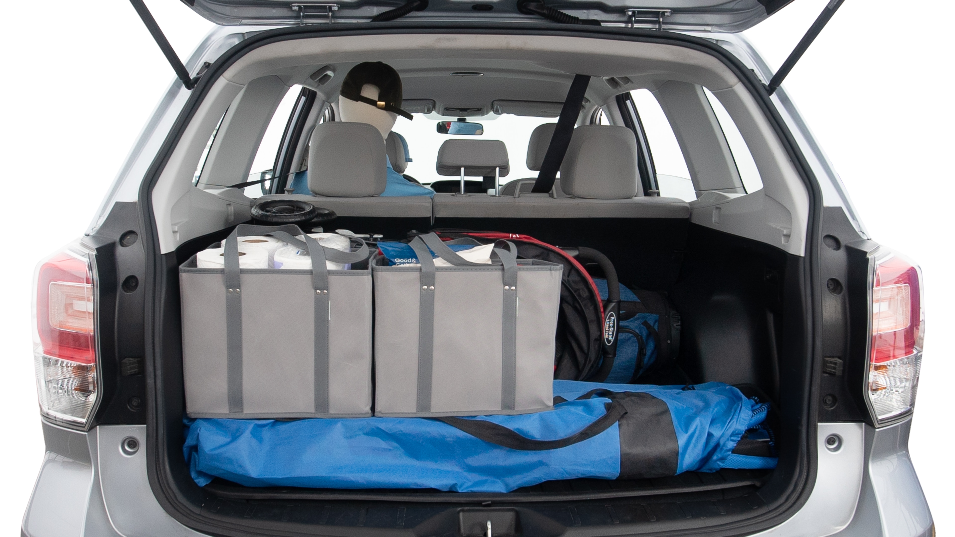 The trunk lid is open showing full view of the trunk. A baby stroller, three grocery carriers, two camping chairs in the carrying bag, and a set of golf clubs are placed inside.