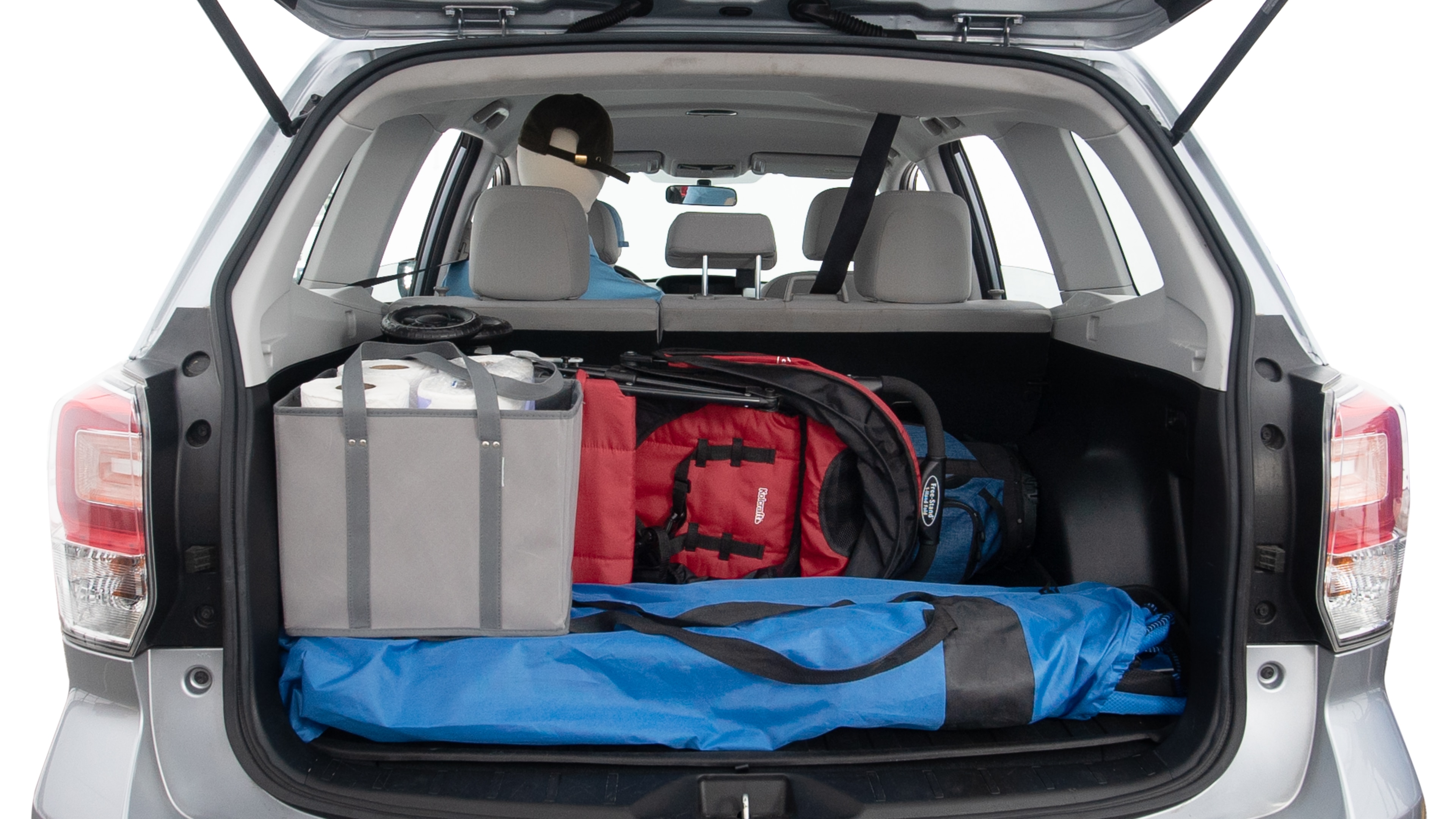 The trunk lid is open showing full view of the trunk. A baby stroller, three grocery carriers, two camping chairs in the carrying bag, and a set of golf clubs are placed inside.