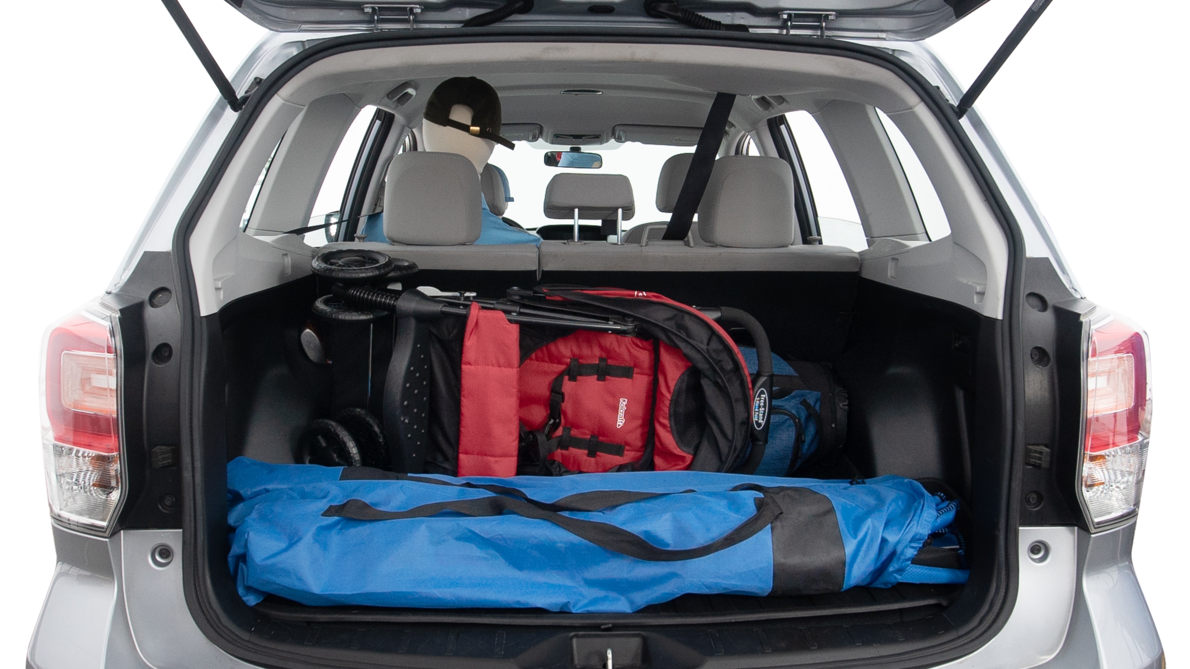 The trunk lid is open showing full view of the trunk. A baby stroller, three grocery carriers, two camping chairs in the carrying bag, and a set of golf clubs are placed inside.
