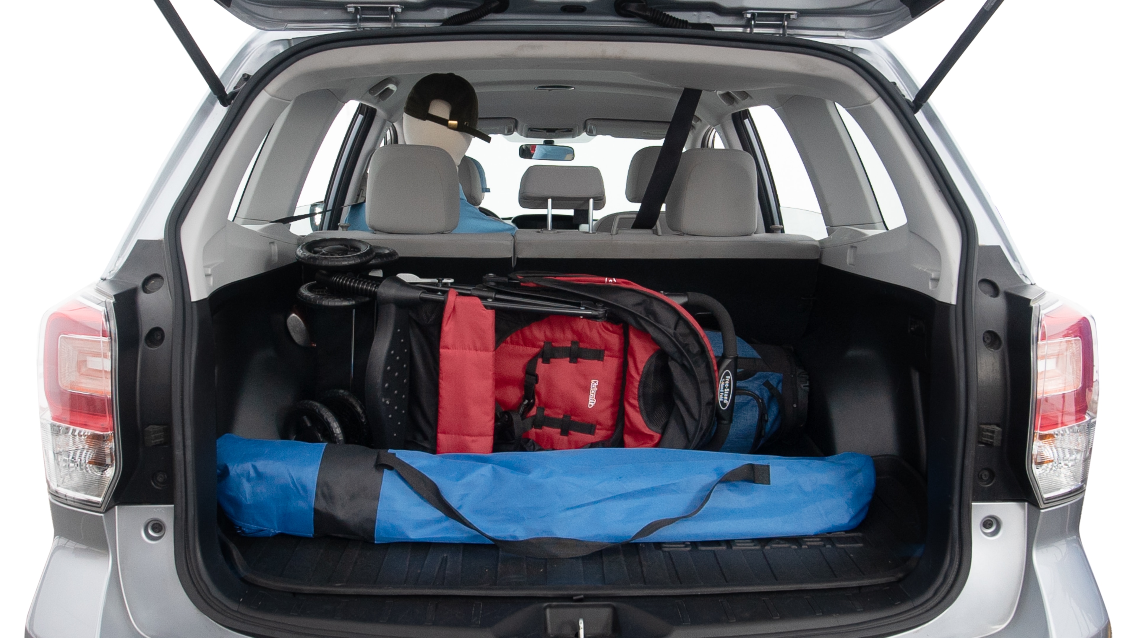 The trunk lid is open showing full view of the trunk. A baby stroller, three grocery carriers, two camping chairs in the carrying bag, and a set of golf clubs are placed inside.