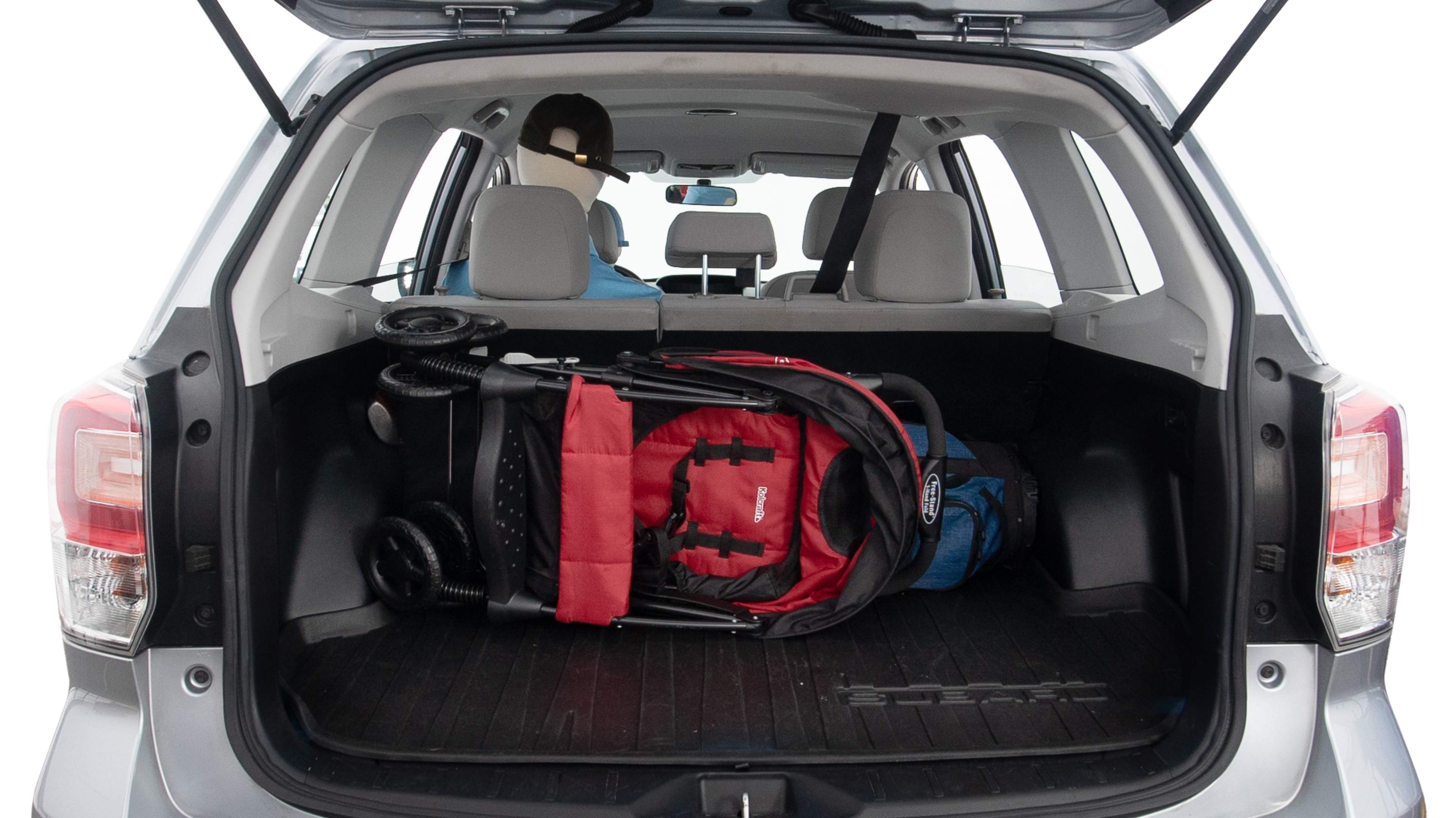 The trunk lid is open showing full view of the trunk. A baby stroller, three grocery carriers, two camping chairs in the carrying bag, and a set of golf clubs are placed inside.