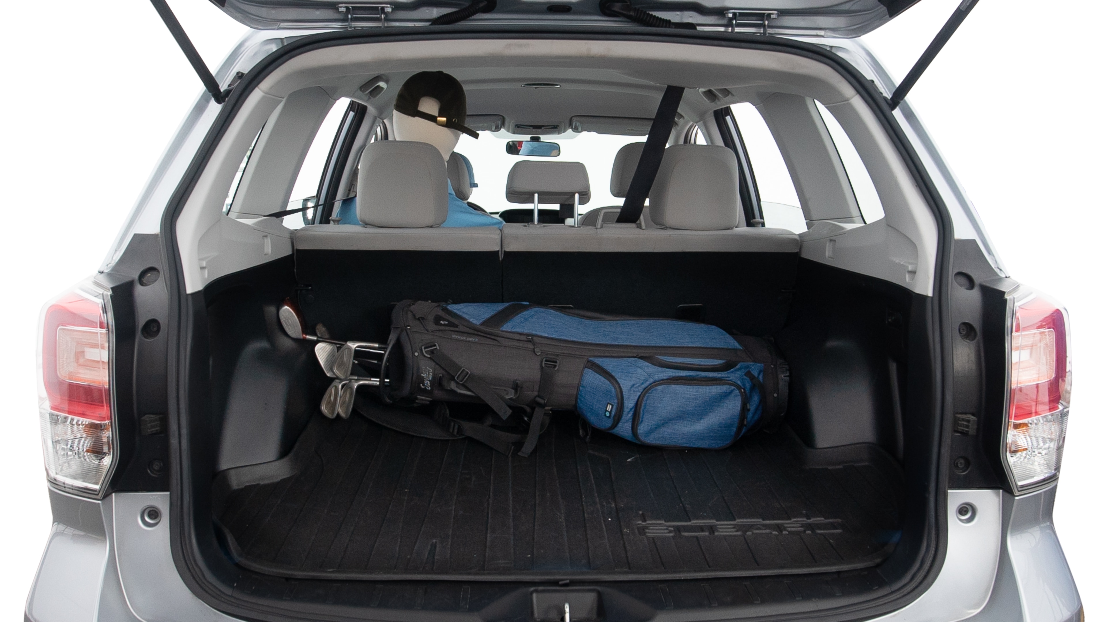 The trunk lid is open showing full view of the trunk. A baby stroller, three grocery carriers, two camping chairs in the carrying bag, and a set of golf clubs are placed inside.