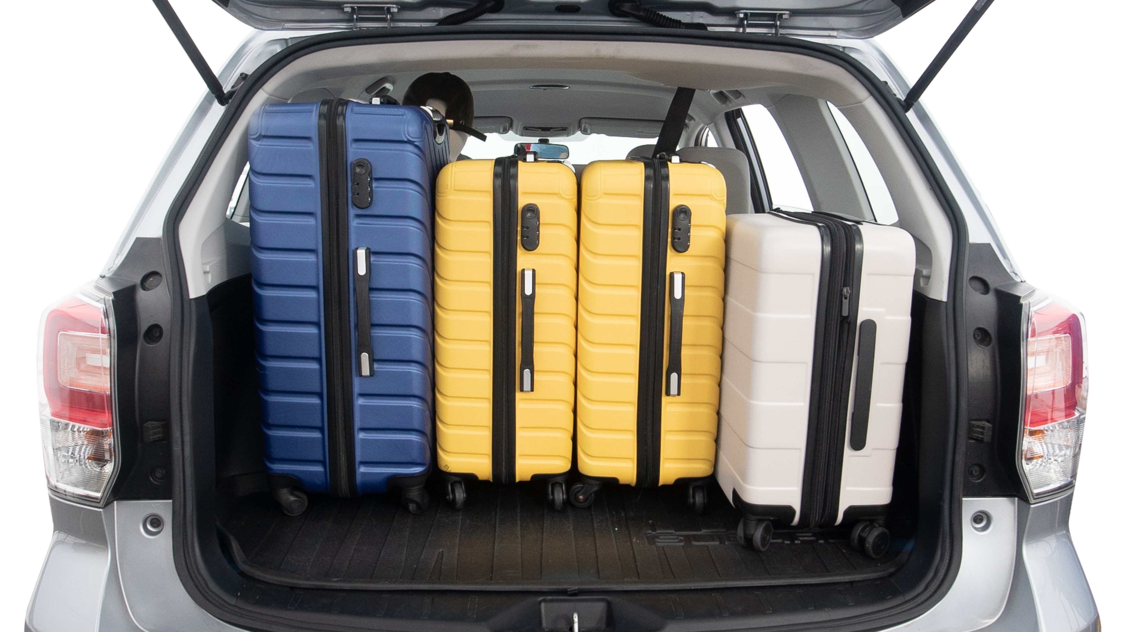 The trunk lid is open, showing full view of the trunk space. One extra large suitcase, two large suitcases and two small suitcases are placed inside.