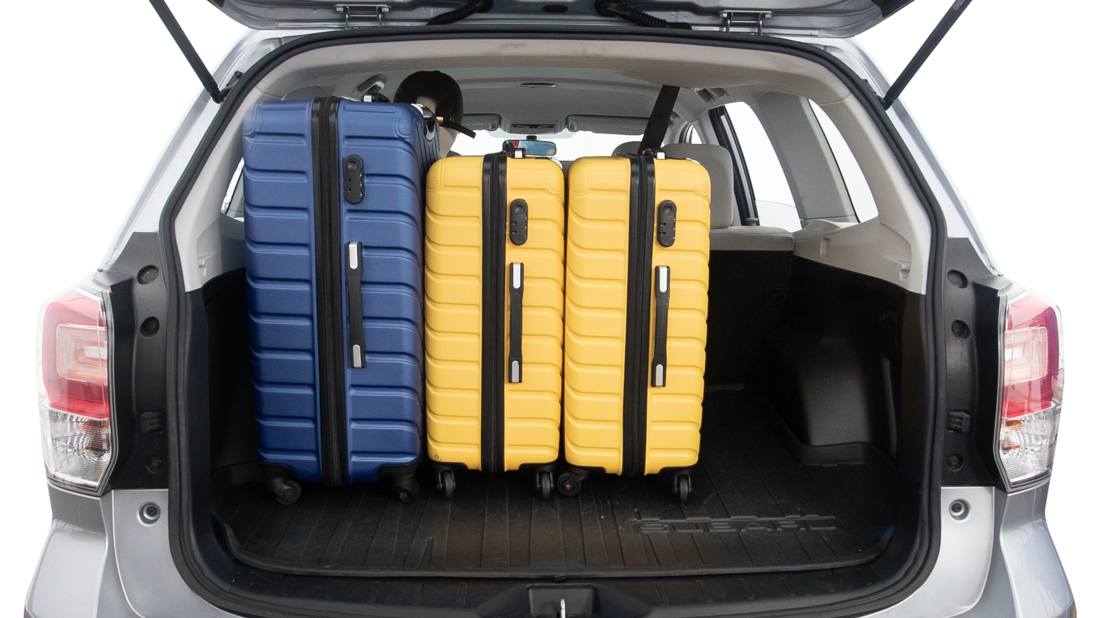 The trunk lid is open, showing full view of the trunk space. One extra large suitcase, two large suitcases and two small suitcases are placed inside.