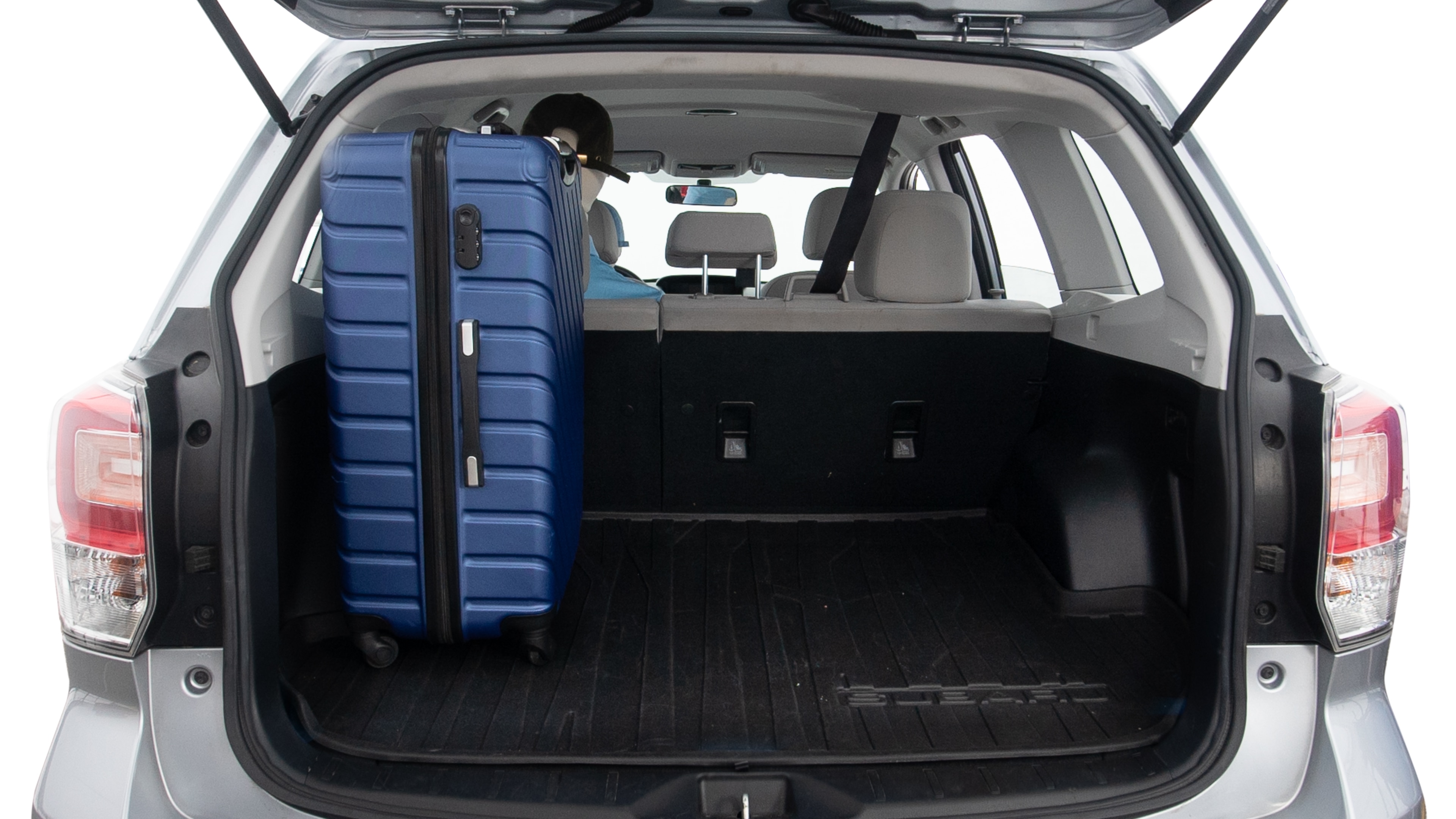The trunk lid is open, showing full view of the trunk space. One extra large suitcase, two large suitcases and two small suitcases are placed inside.