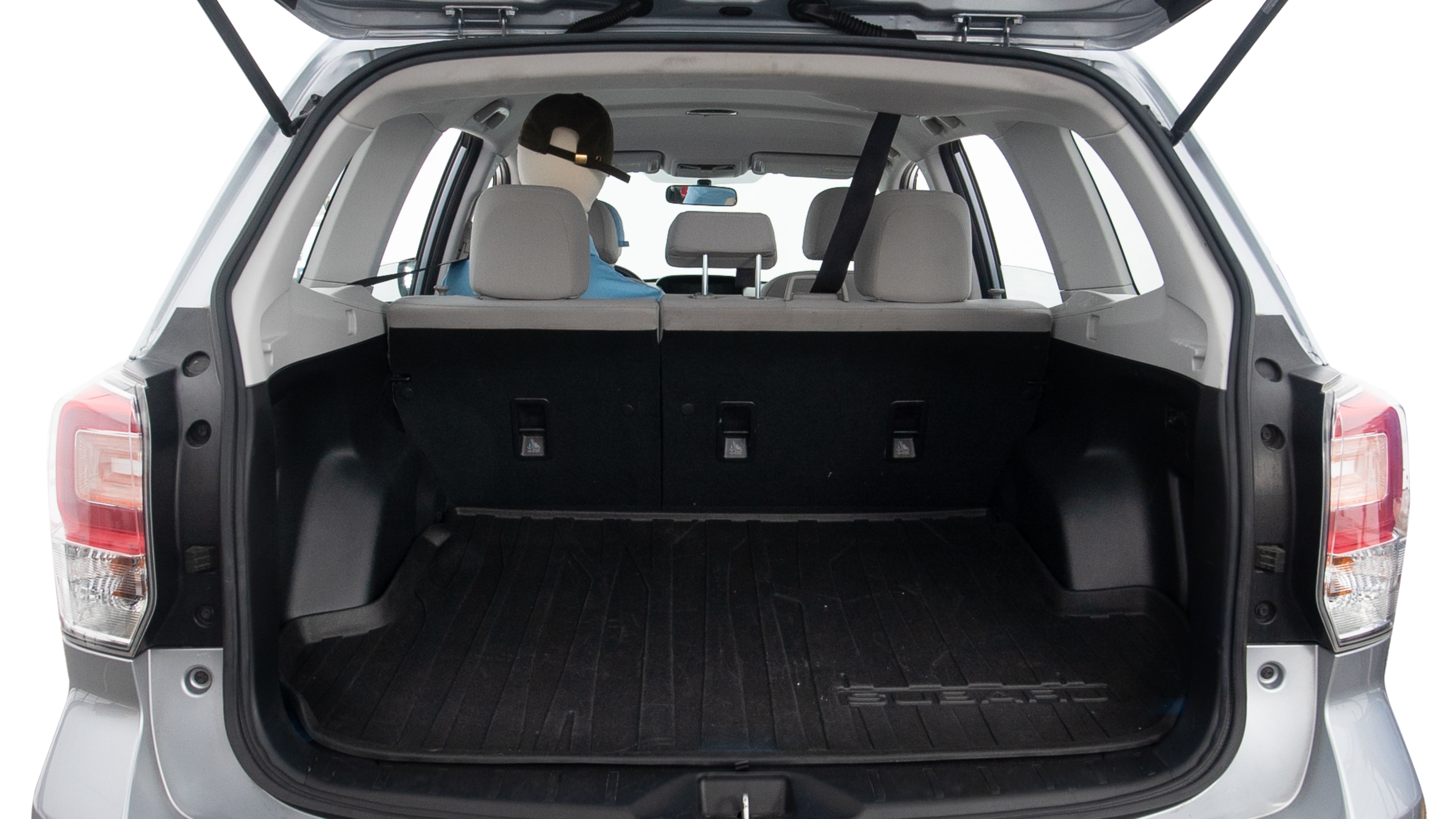 The trunk lid is open, showing full view of the trunk space. One extra large suitcase, two large suitcases and two small suitcases are placed inside.