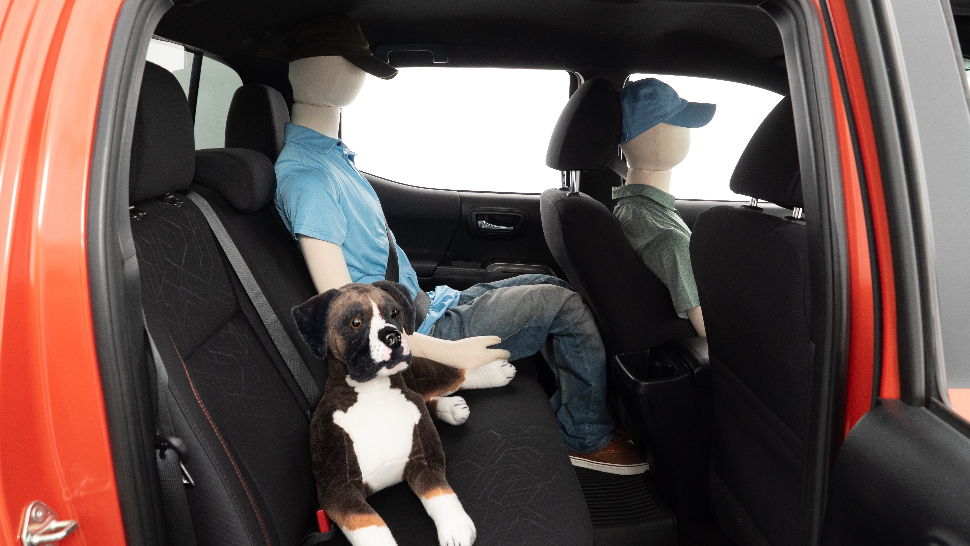 A series of second-row backseat photos is shown including one seating a baby seat and one seating a 6'1" mannequin.