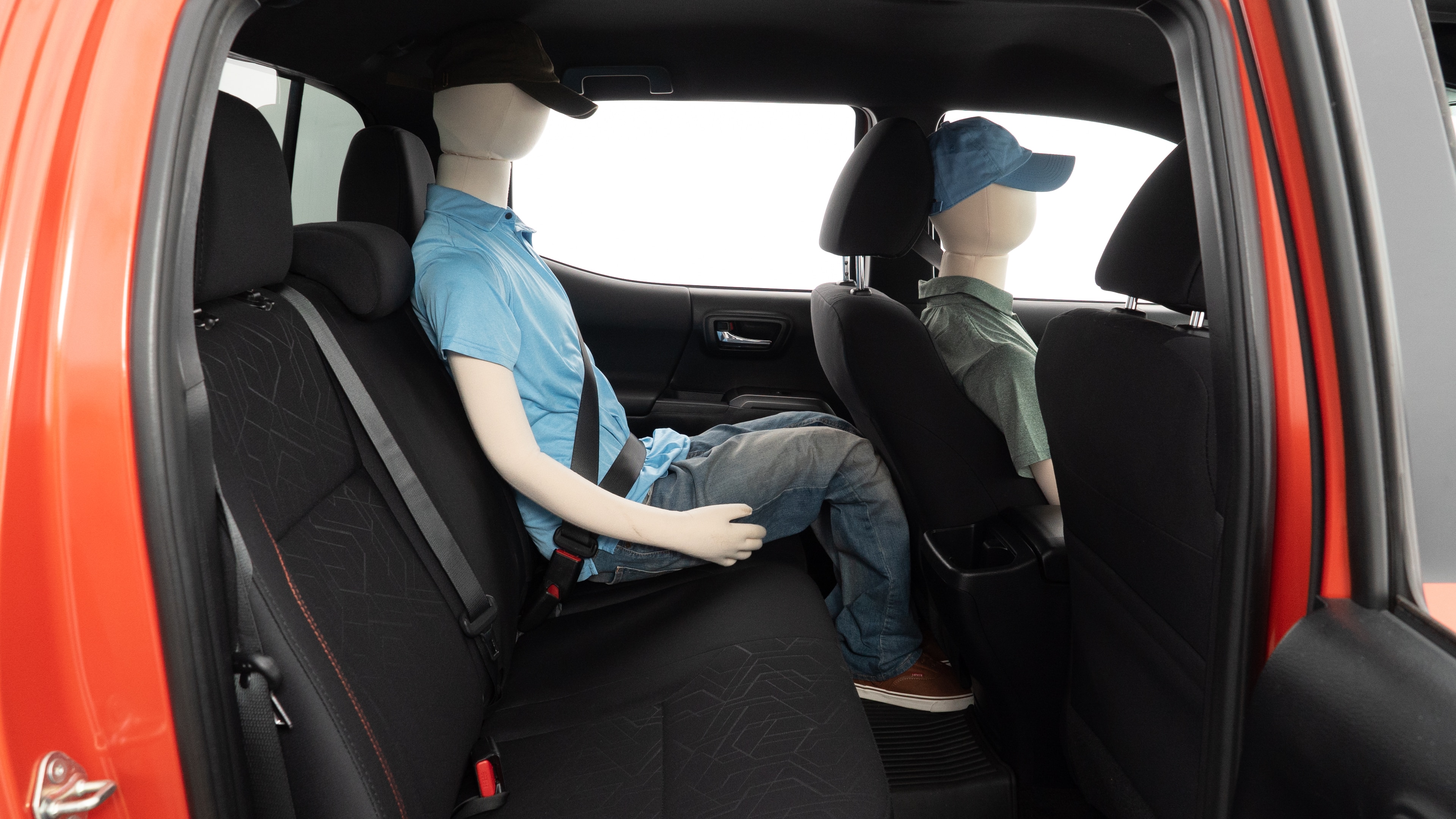 A series of second-row backseat photos is shown including one seating a baby seat and one seating a 6'1" mannequin.
