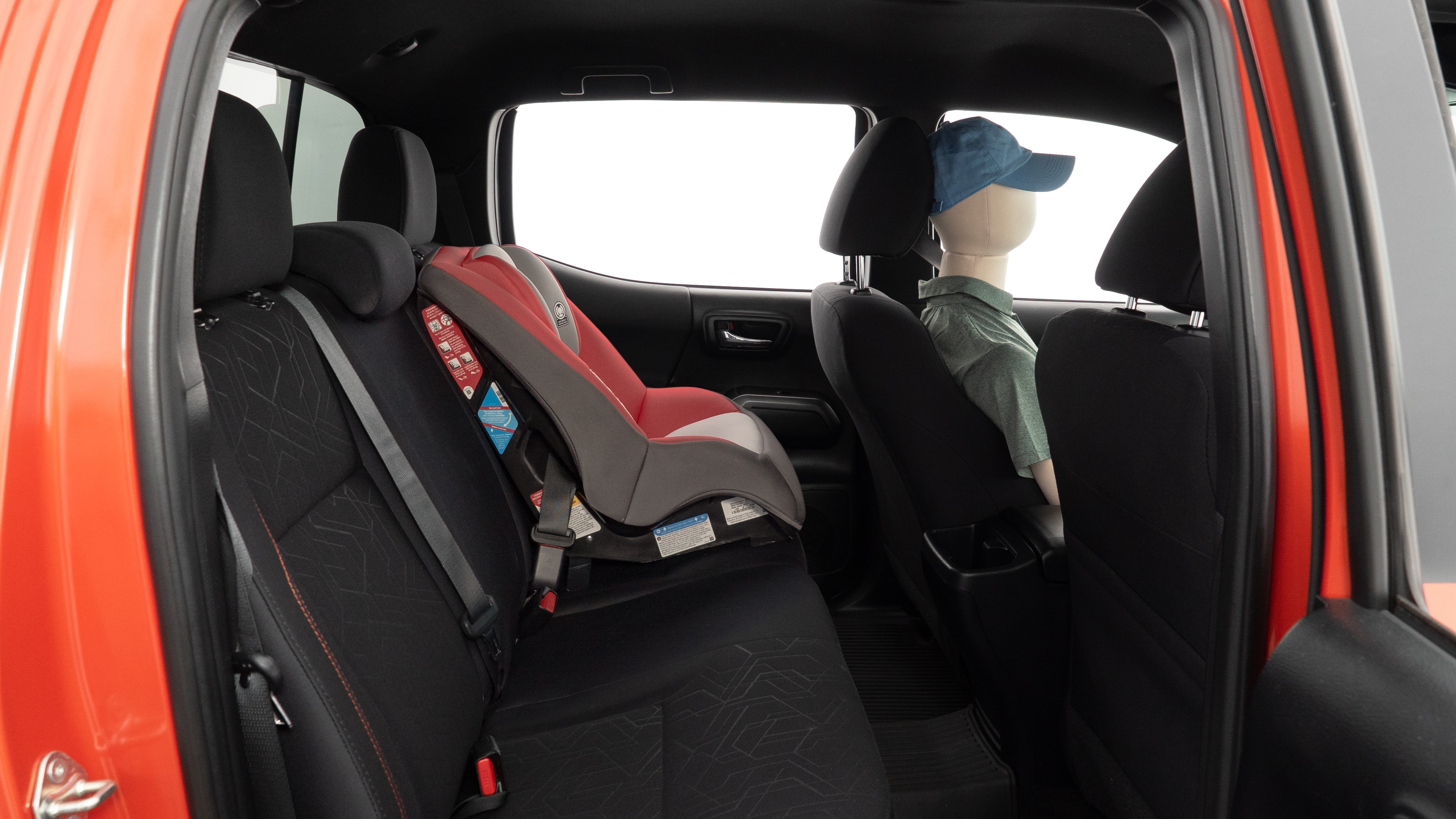 A series of second-row backseat photos is shown including one seating a baby seat and one seating a 6'1" mannequin.