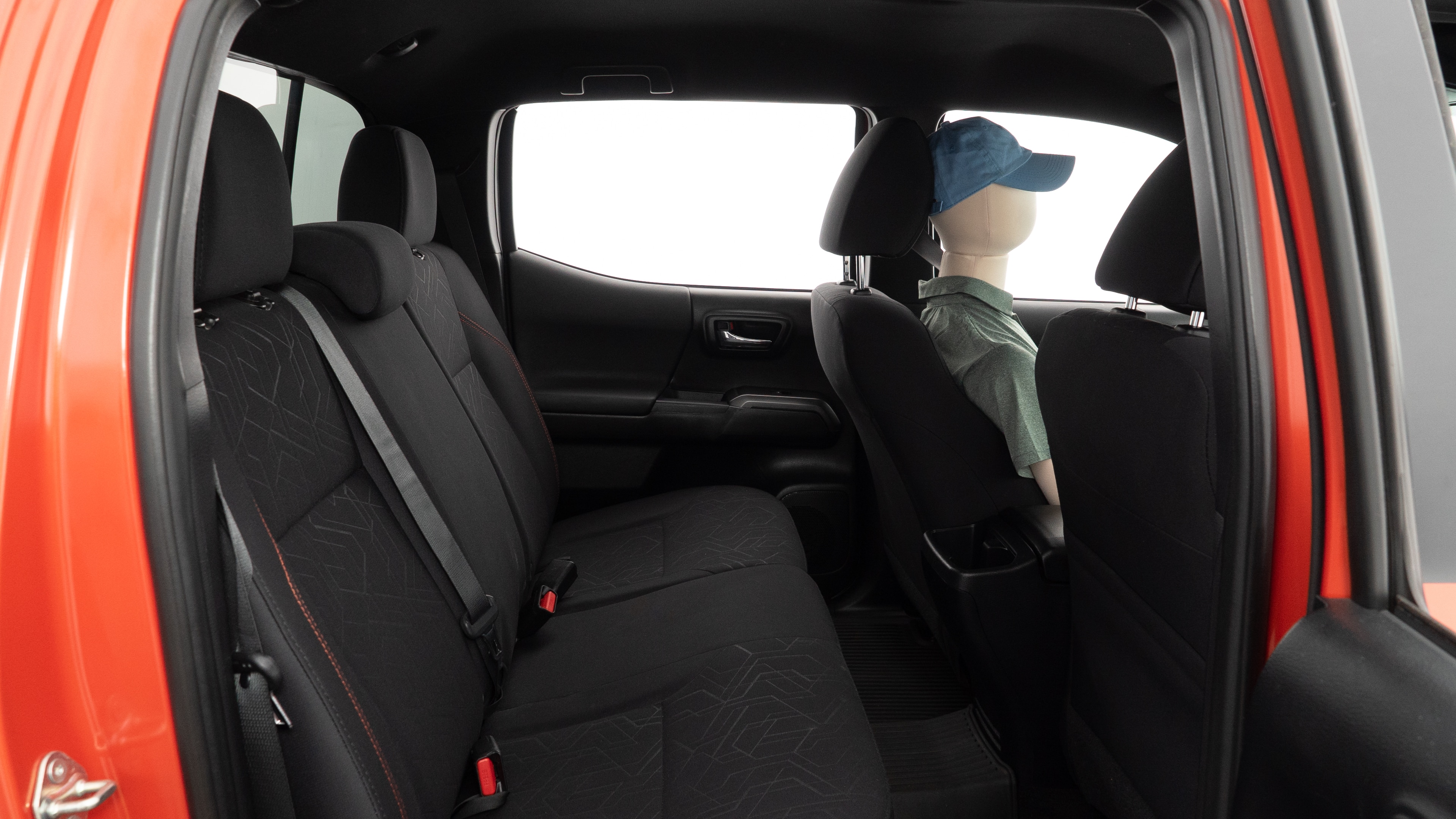 A series of second-row backseat photos is shown including one seating a baby seat and one seating a 6'1" mannequin.